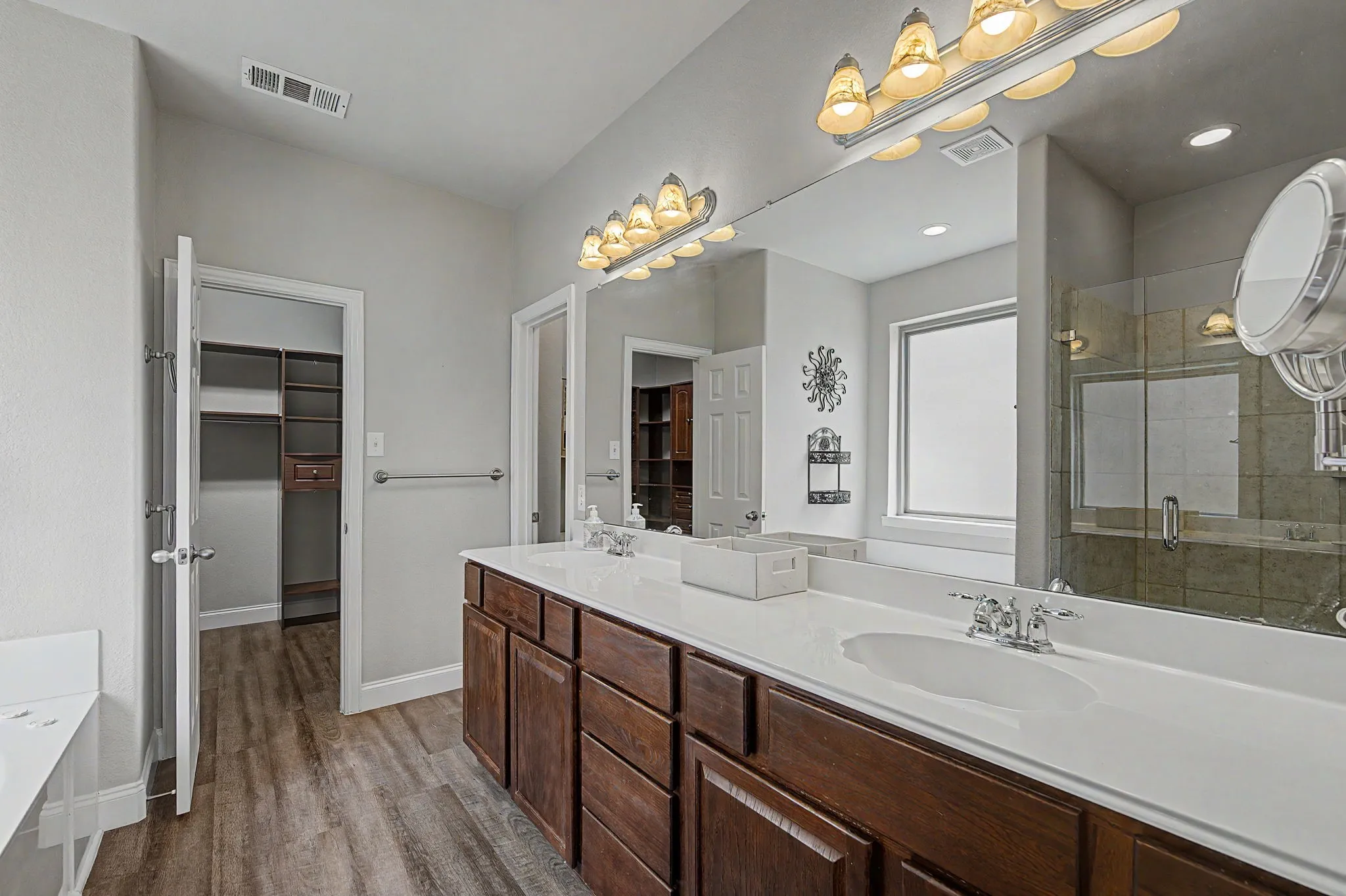 Large bathroom vanity with dual sinks and plenty of storage.