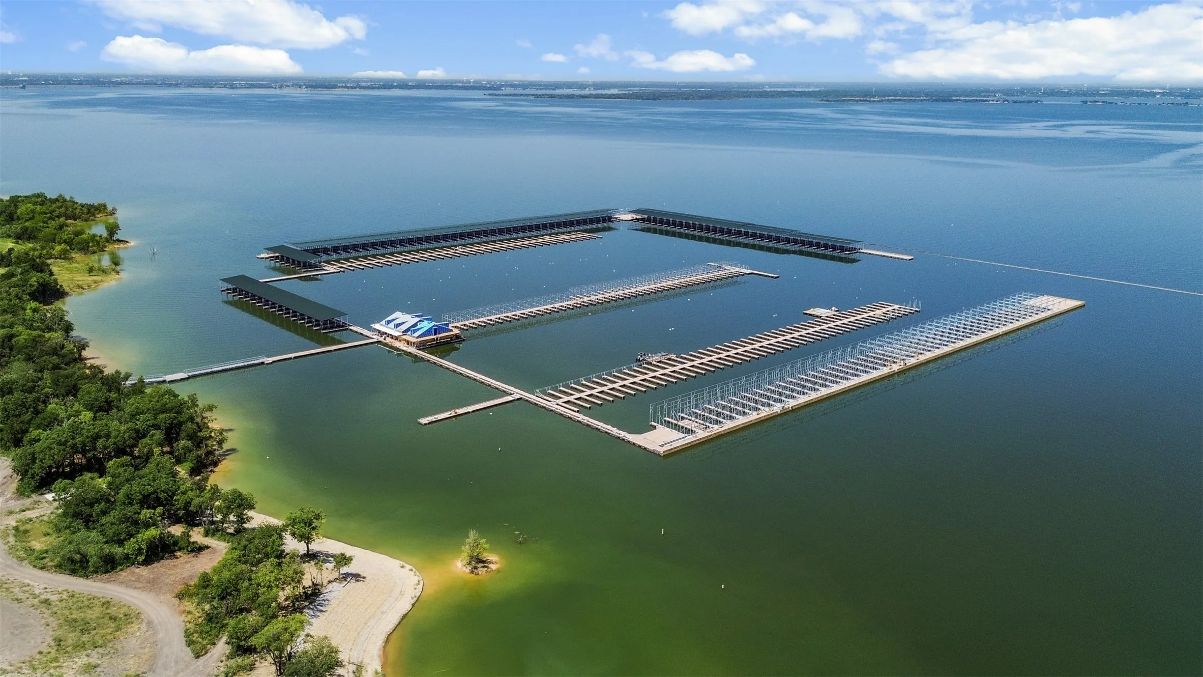 Expansive marina with multiple covered boat slips and extensive open dockage