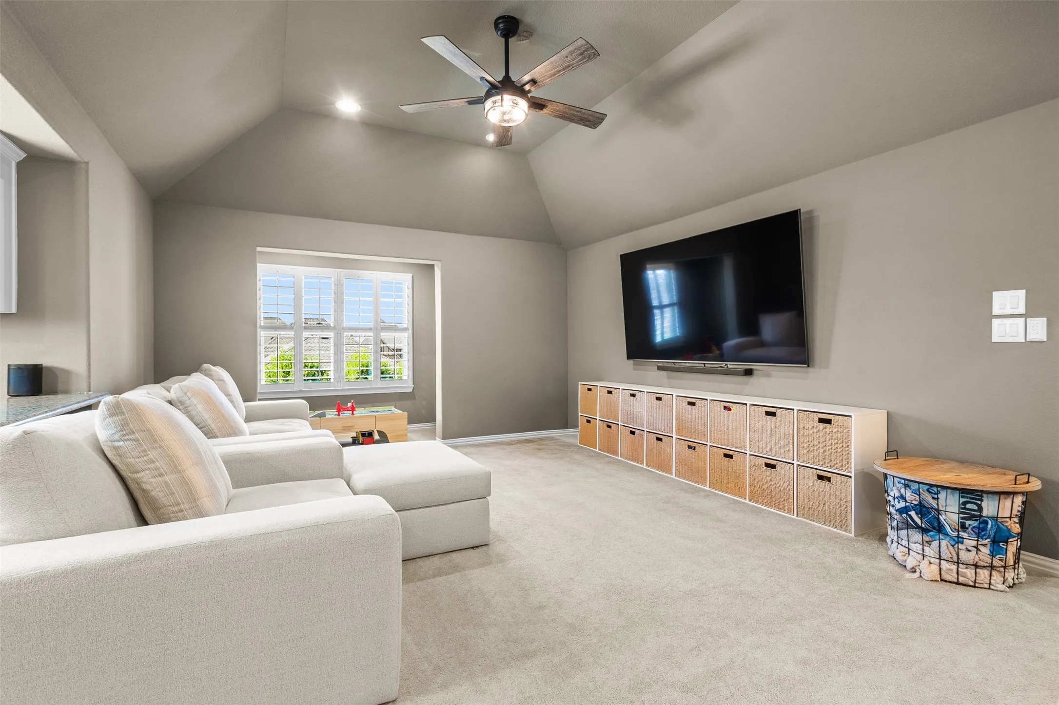 Carpeted room featuring a vaulted ceiling with recessed lighting and a ceiling fan