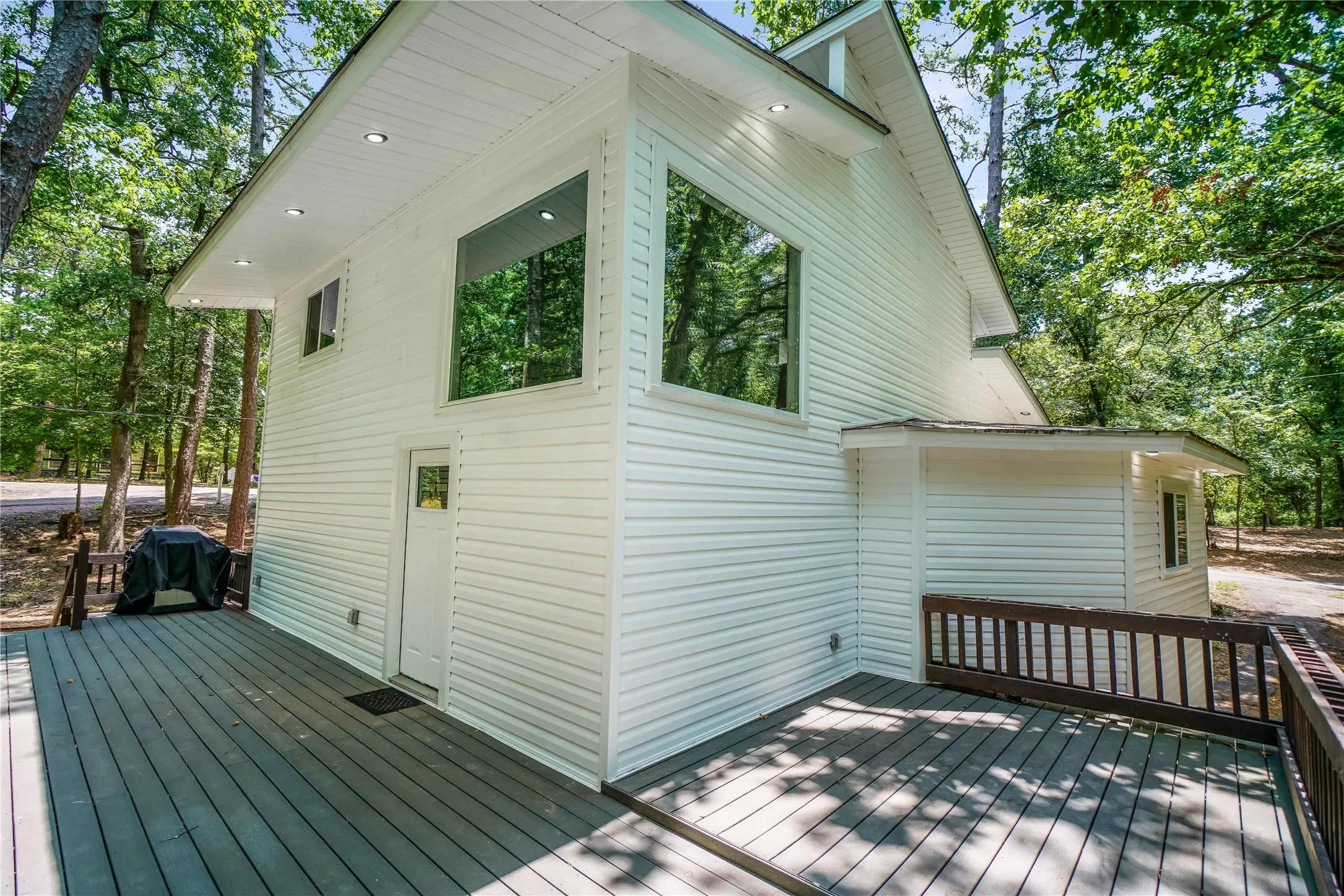 Spacious outdoor deck with dark wood-finish railing