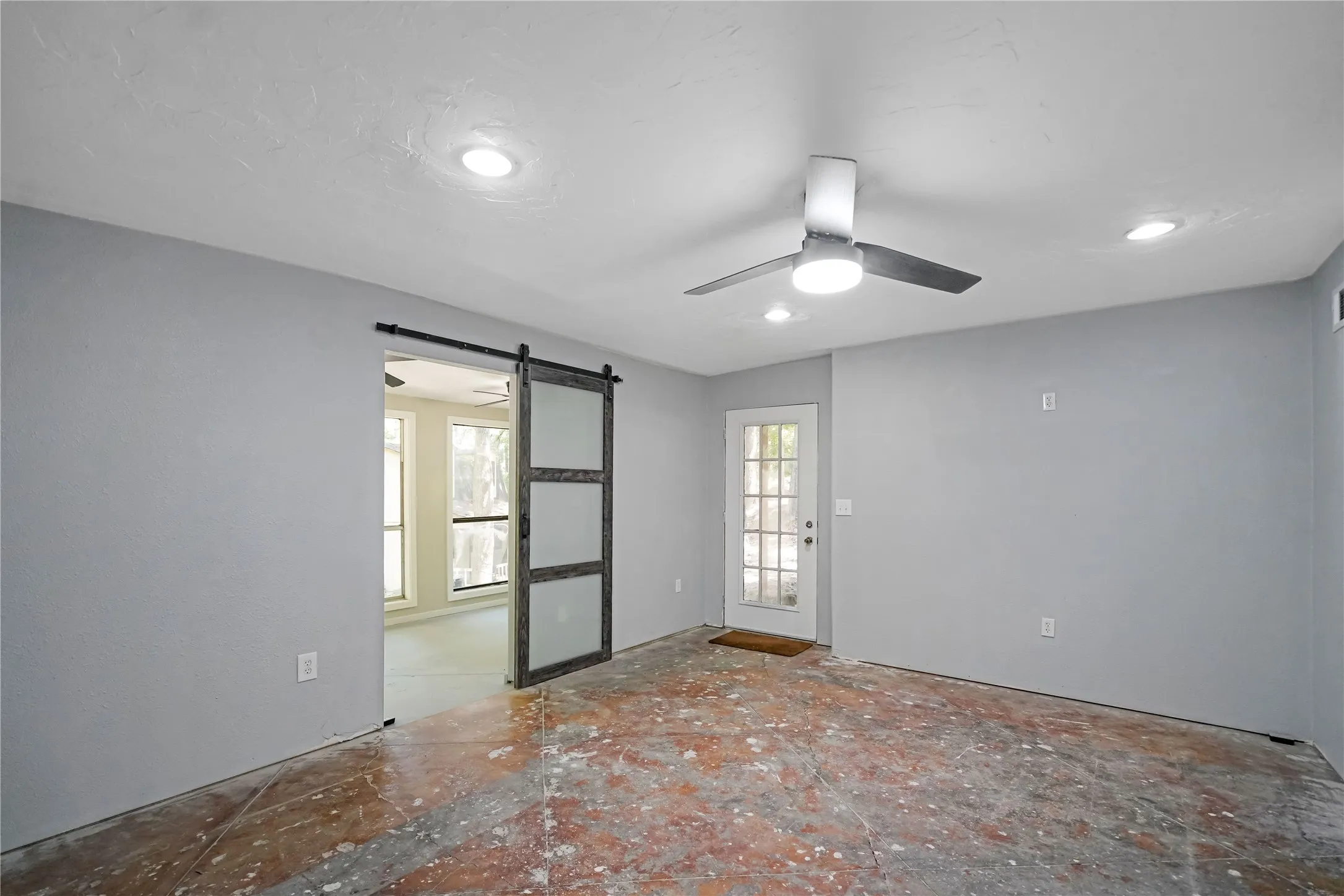 Interior space featuring a white ceiling, recessed lighting, and a ceiling fan with light