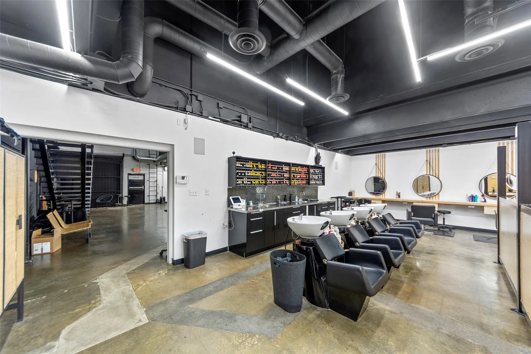 Commercial space featuring a salon area with multiple wash stations and styling areas