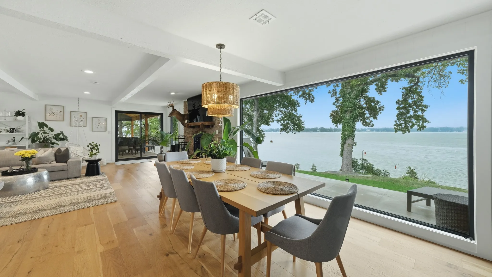 Expansive waterfront dining area featuring a full-wall picture window overlooking the water