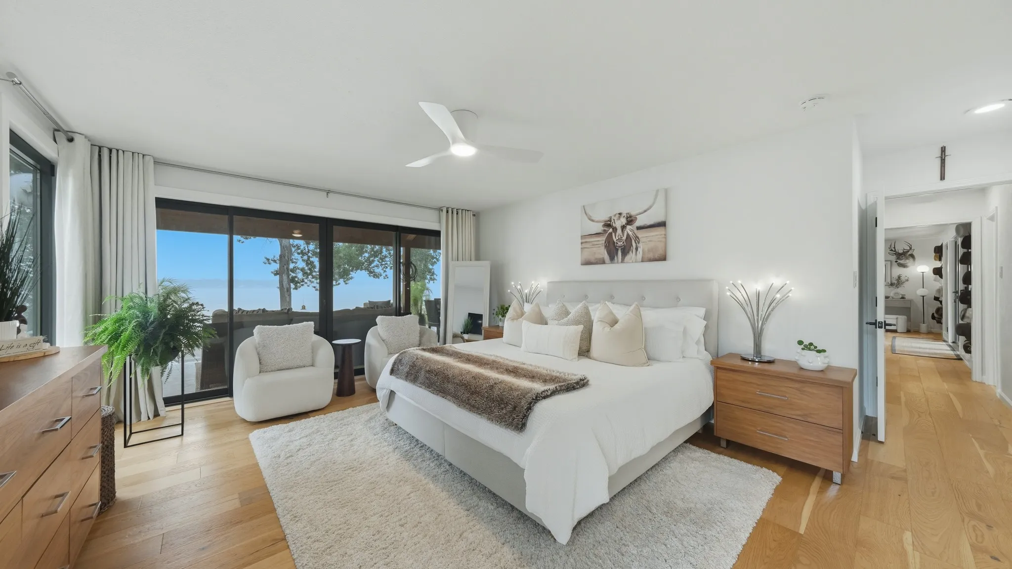 Bedroom featuring expansive floor-to-ceiling windows, wood-finish flooring, a contemporary ceiling fan, and recessed lighting