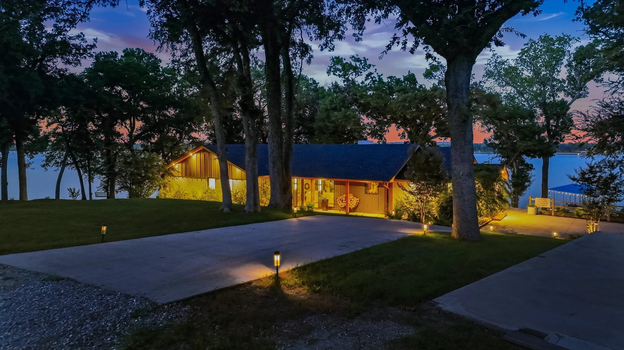 Stone and wood-sided residence featuring a gabled roofline and multiple windows