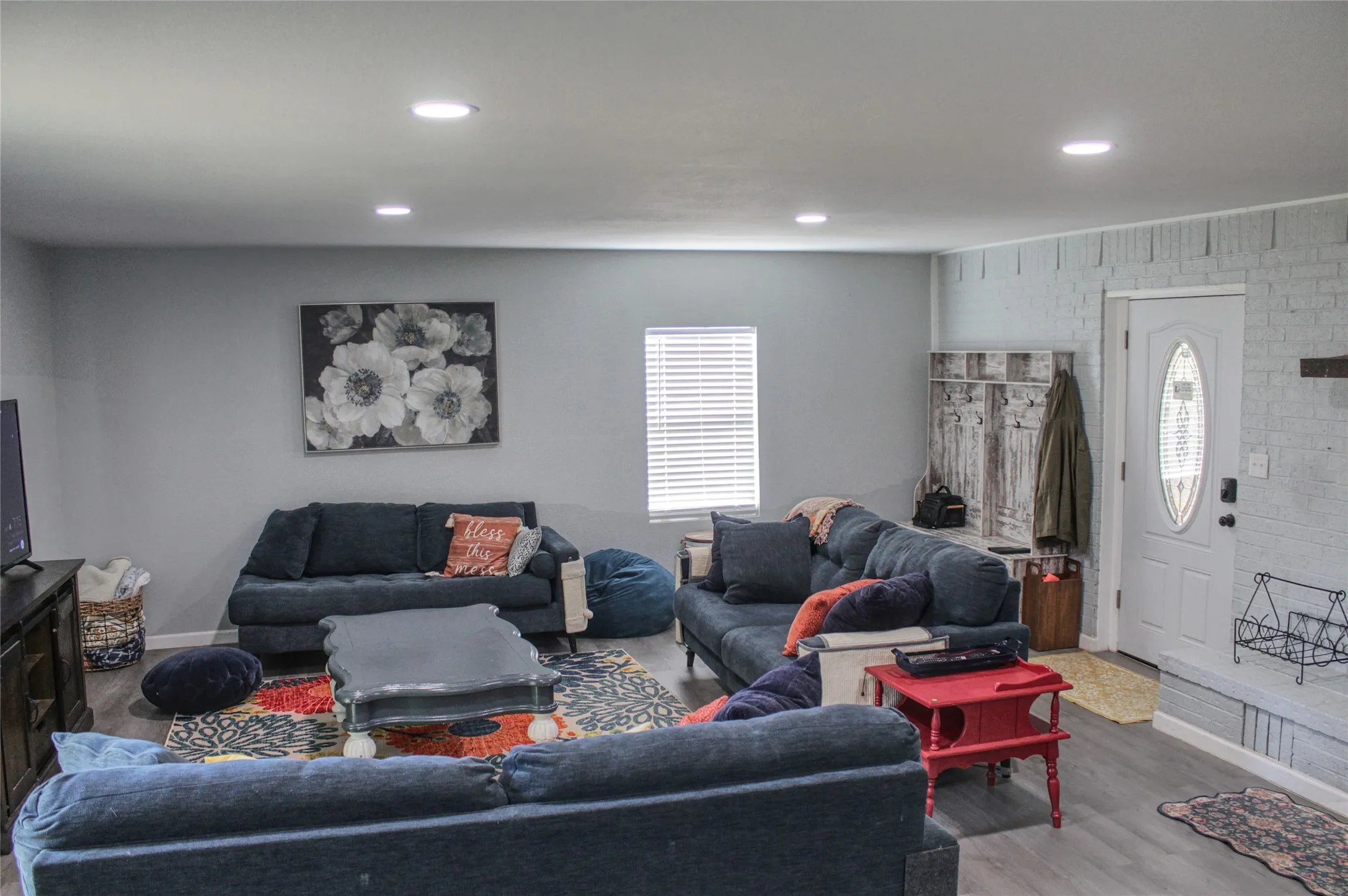 Spacious living area featuring recessed lighting and wood-finish flooring