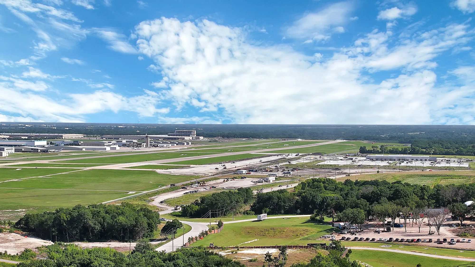 Expansive grounds featuring a vast paved runway system and multiple associated buildings
