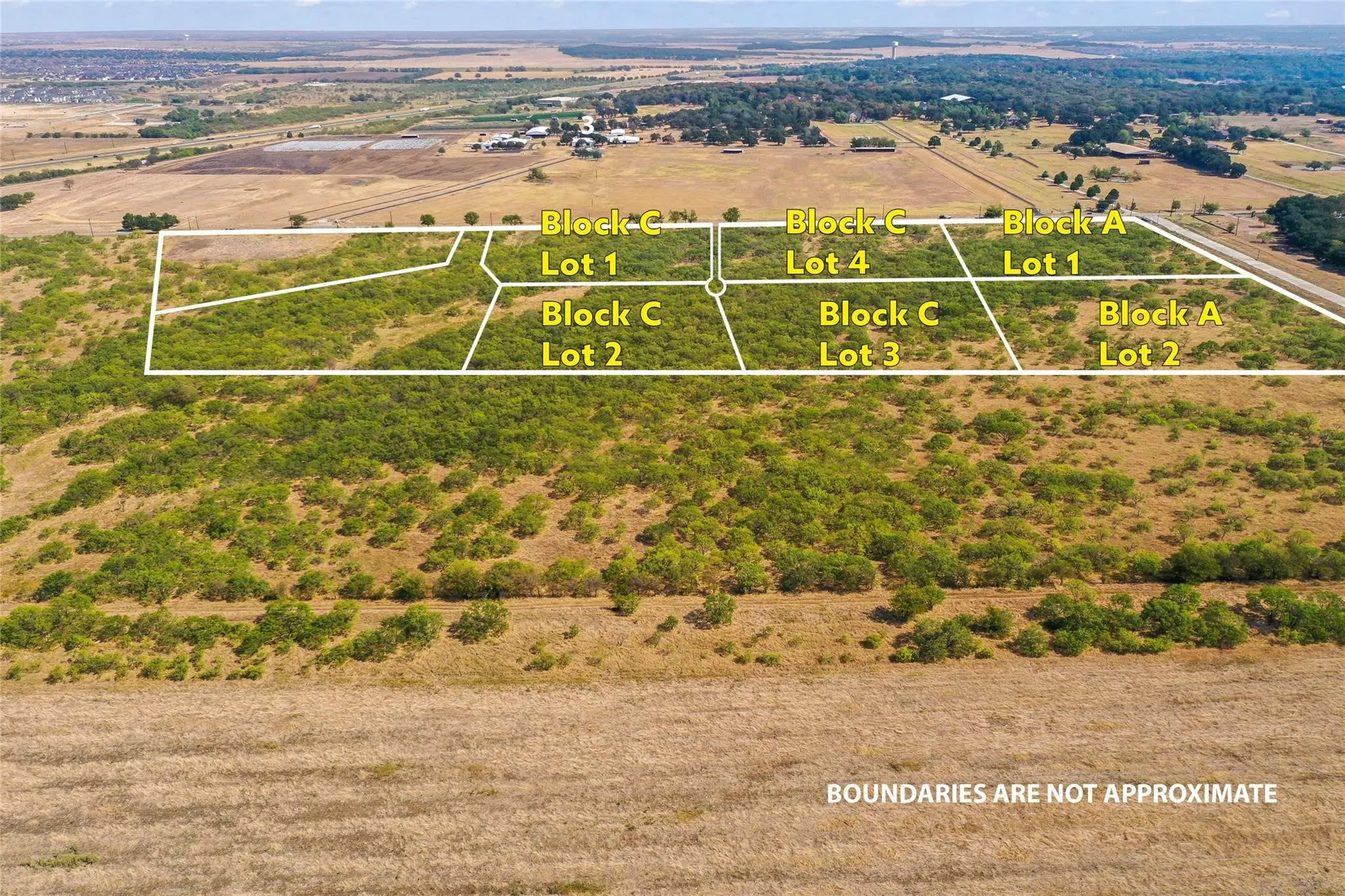 Aerial perspective of multiple undeveloped parcels, featuring Block C Lots 1, 2, 3, and 4, alongside Block A Lots 1 and 2
