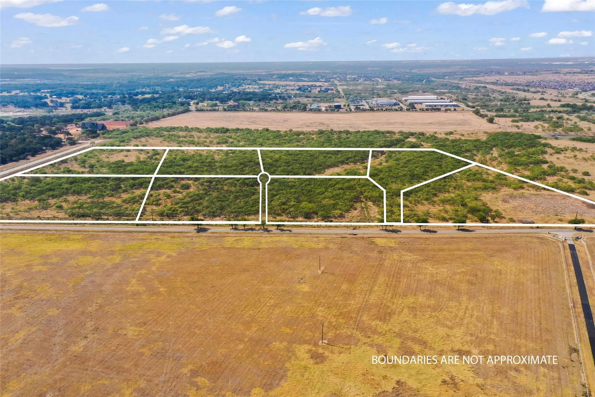 Expansive aerial showcasing multiple subdivided land parcels featuring natural vegetation