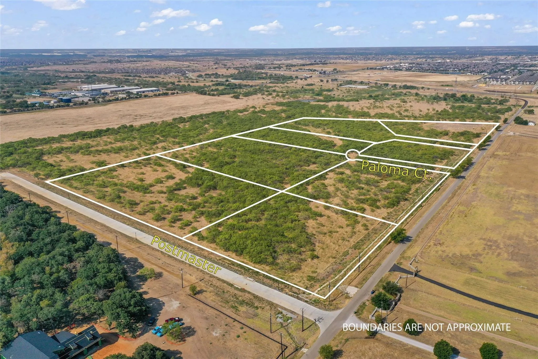 Aerial view of multiple subdivided land parcels, featuring partial road frontage on Postmaster and Paloma Ct