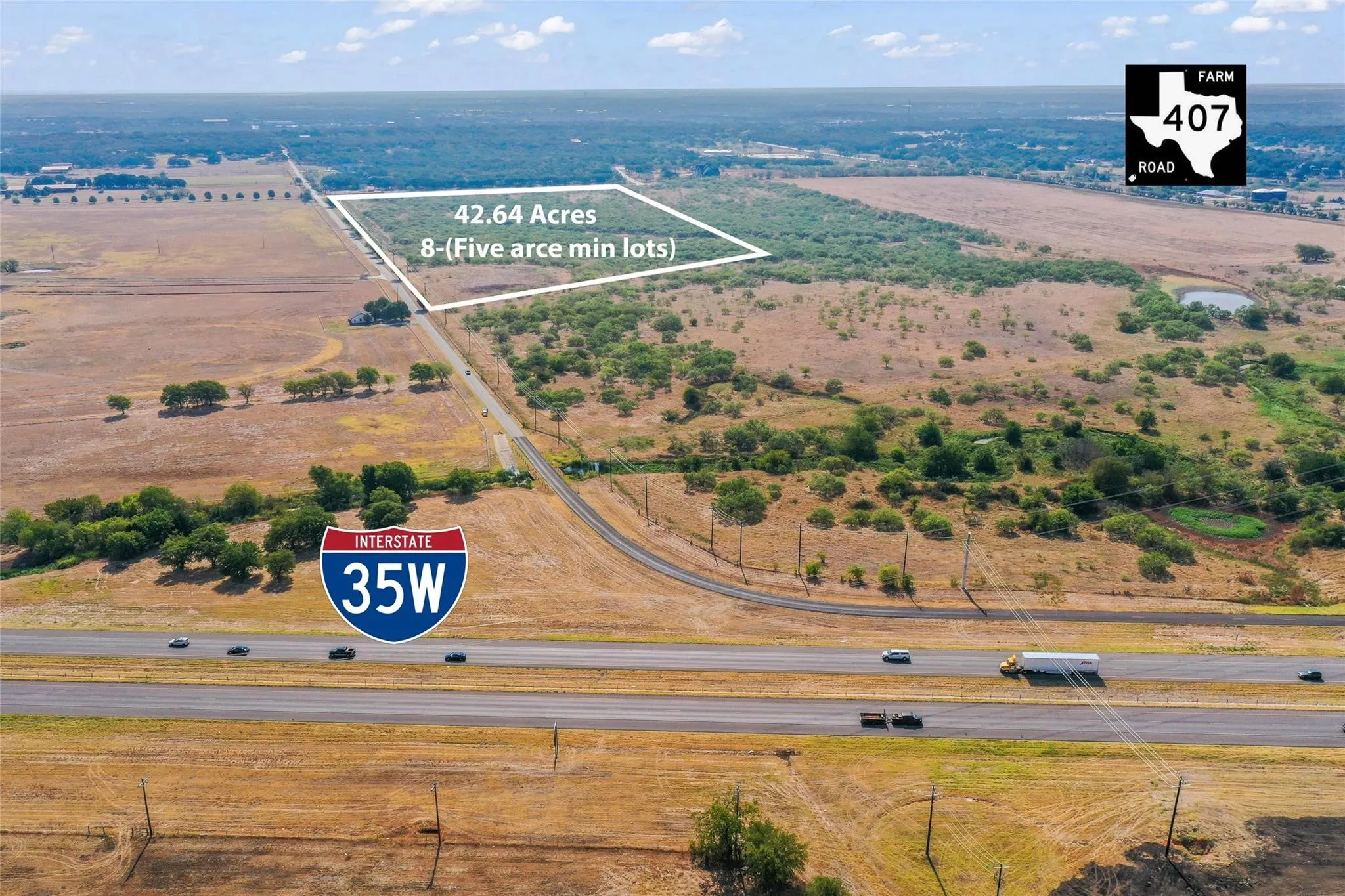 Expansive 42.64-acre parcel featuring significant road frontage, natural tree coverage, and a visible water retention pond