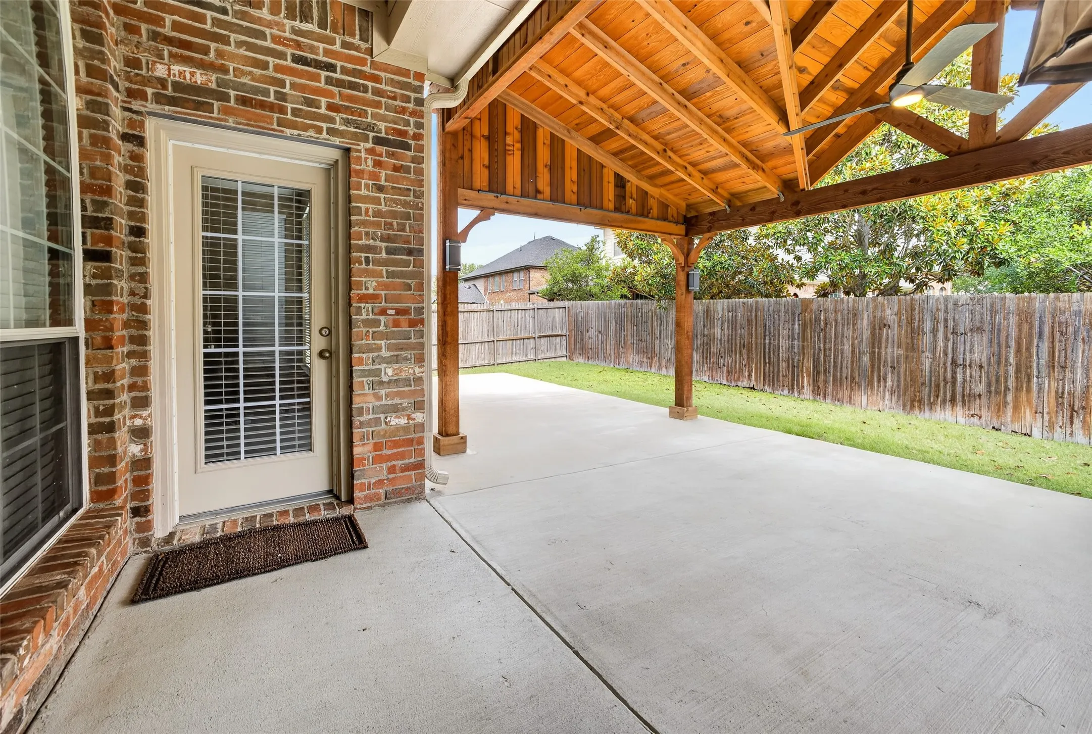 Expansive covered patio featuring exposed wood beams, a ceiling fan, and recessed lighting