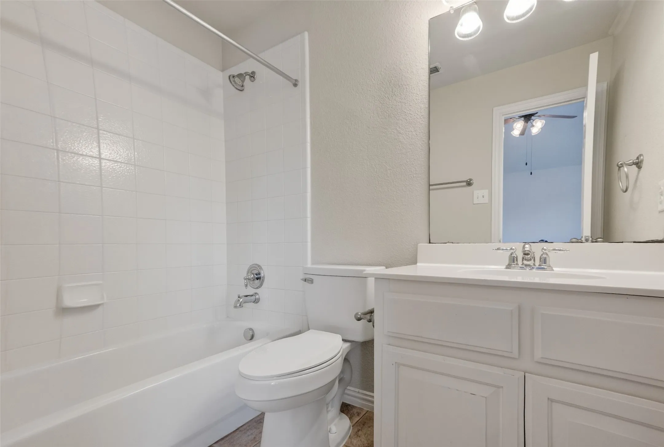 Bathroom featuring a white vanity with paneled cabinetry, a built-in sink, and a chrome faucet (inside of guest quarters room)