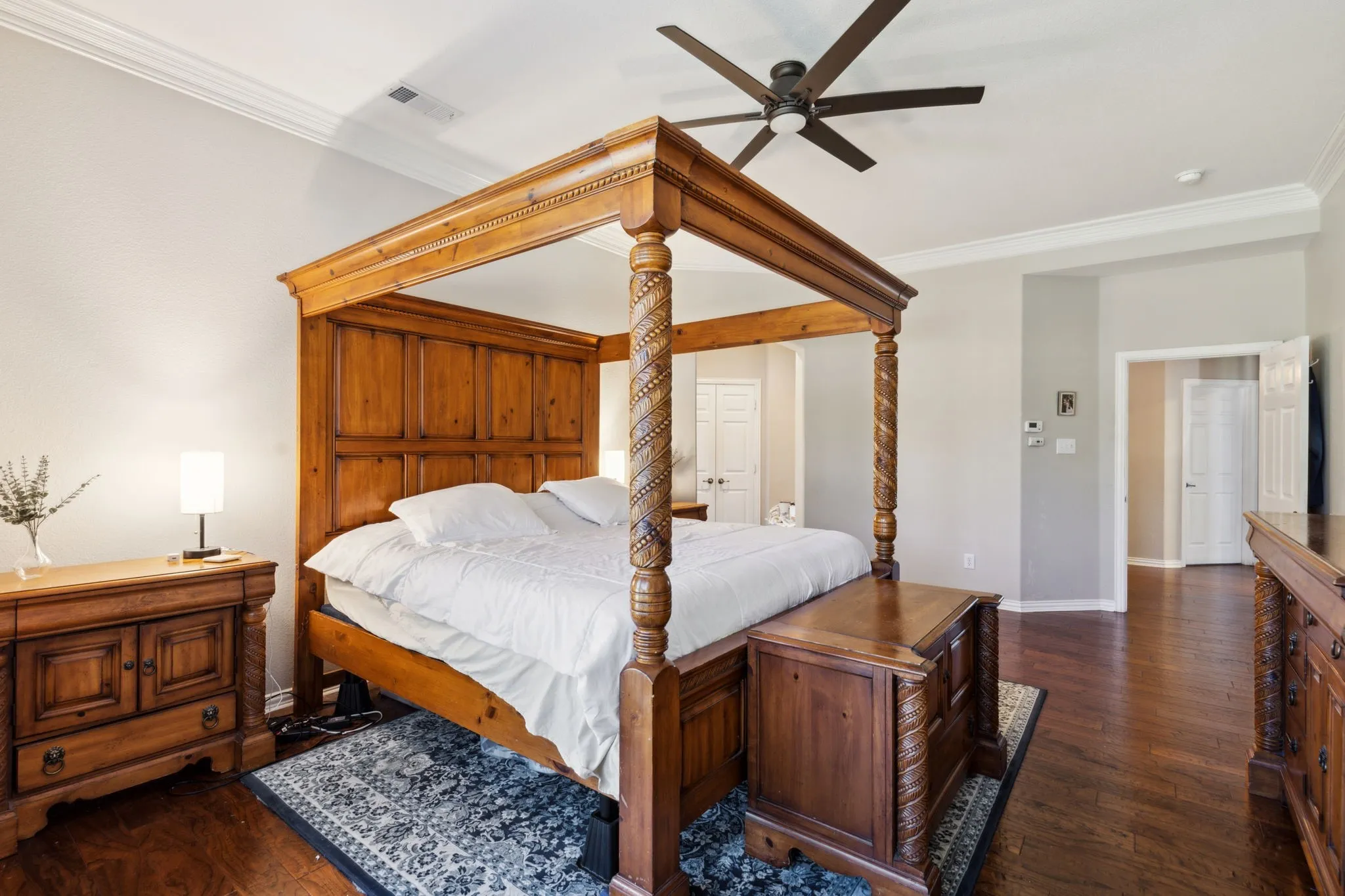 The primary bedroom enjoys a high ceiling and is quite spacious.