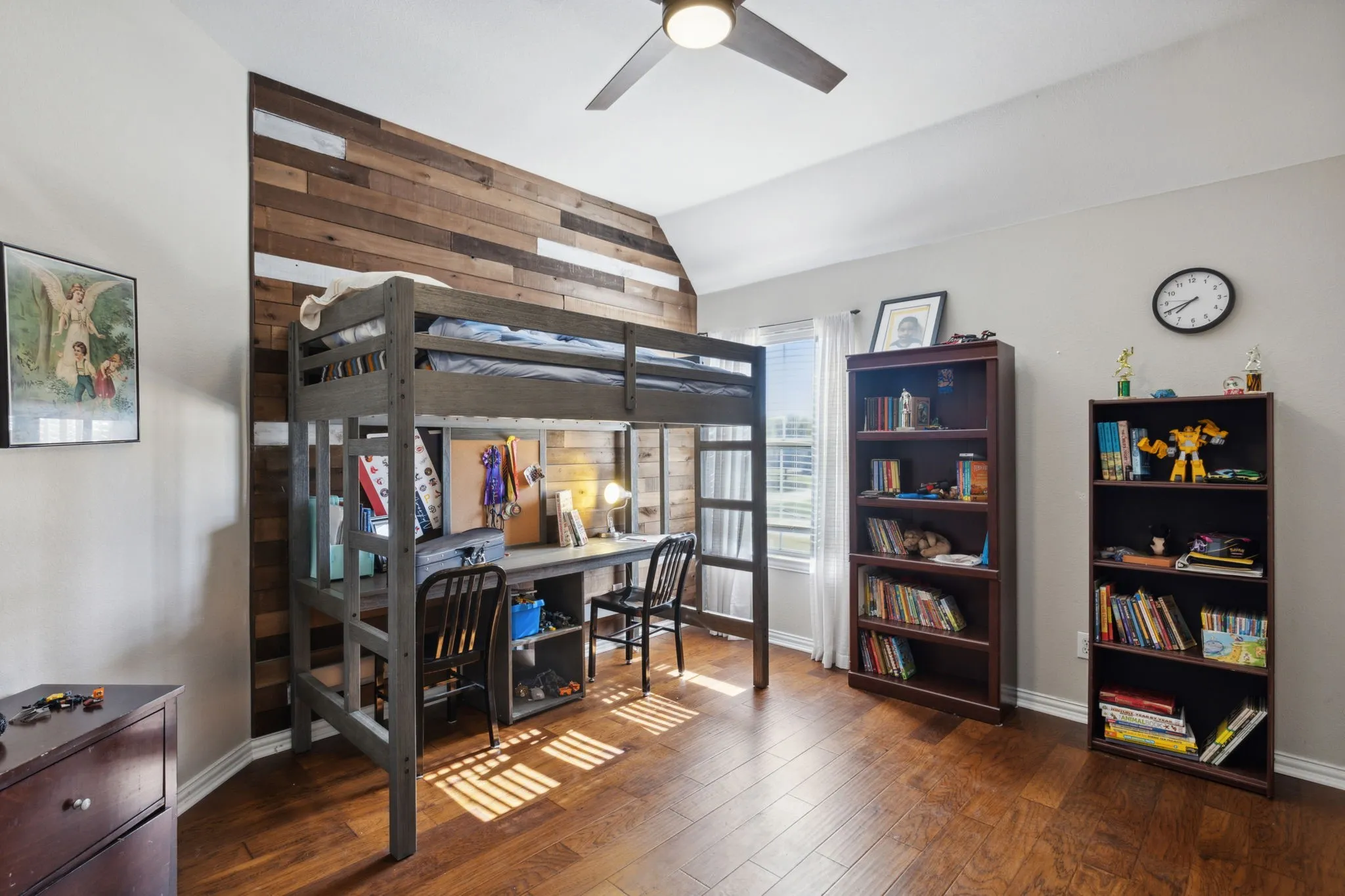 Split secondary bedroom on the second floor with walk-in closet, ceiling and wood flooring.
