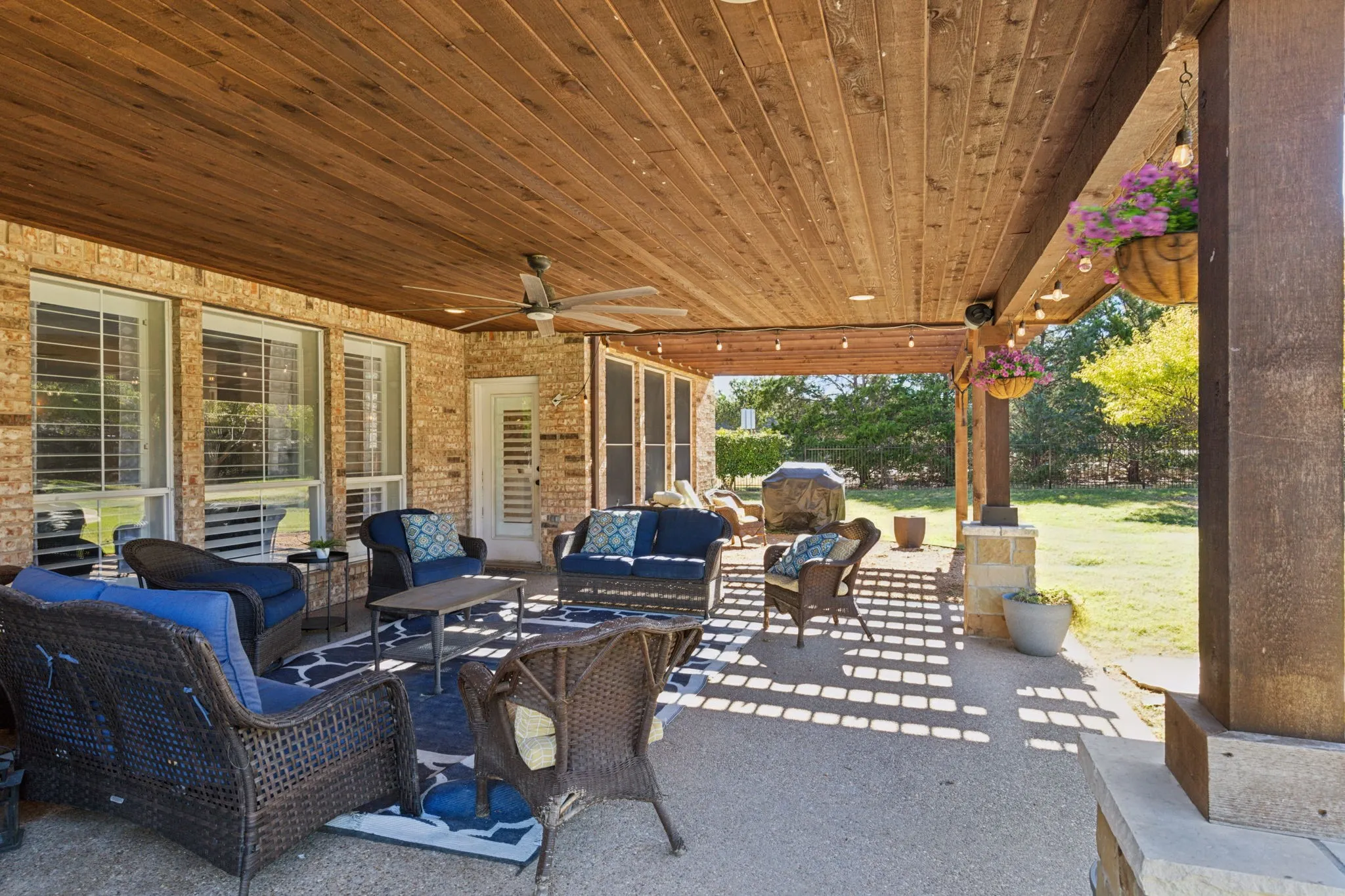 Large cedar plank covered patio with ceiling fan provides a wonderful outdoor living space.