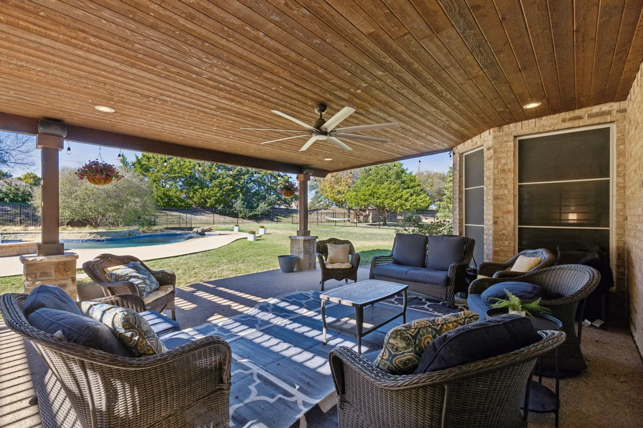 Looking from the outdoor living space toward the refreshing pool.