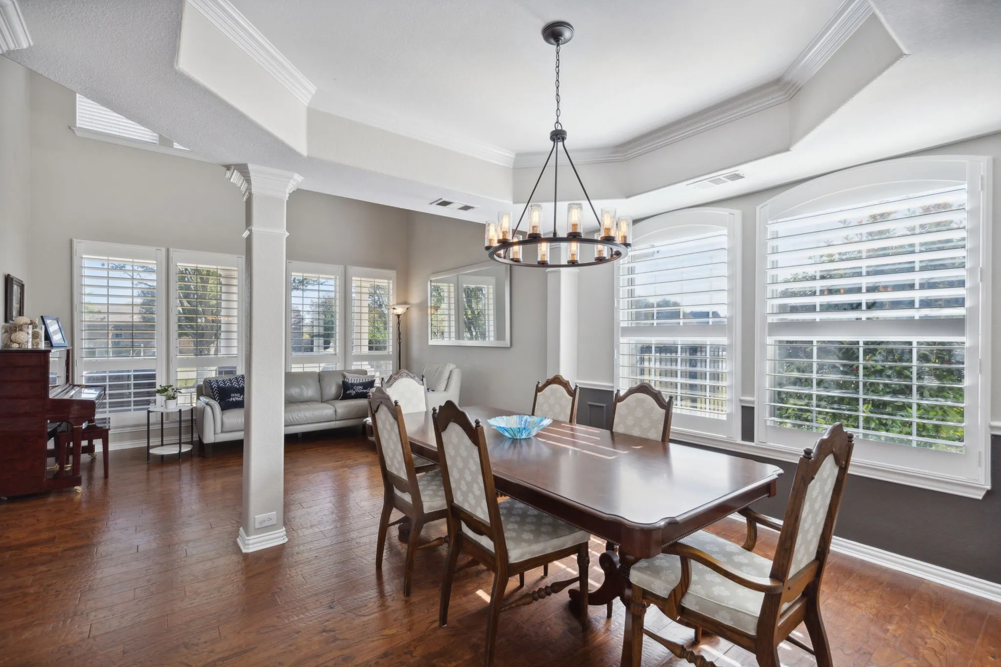 Perfect for entertaining, you have plenty of room for guests to mingle with the open floorplan between the living room and the dining room. The formal dining space has tray ceiling with crown moulding, plantation shutters and updated lighting.