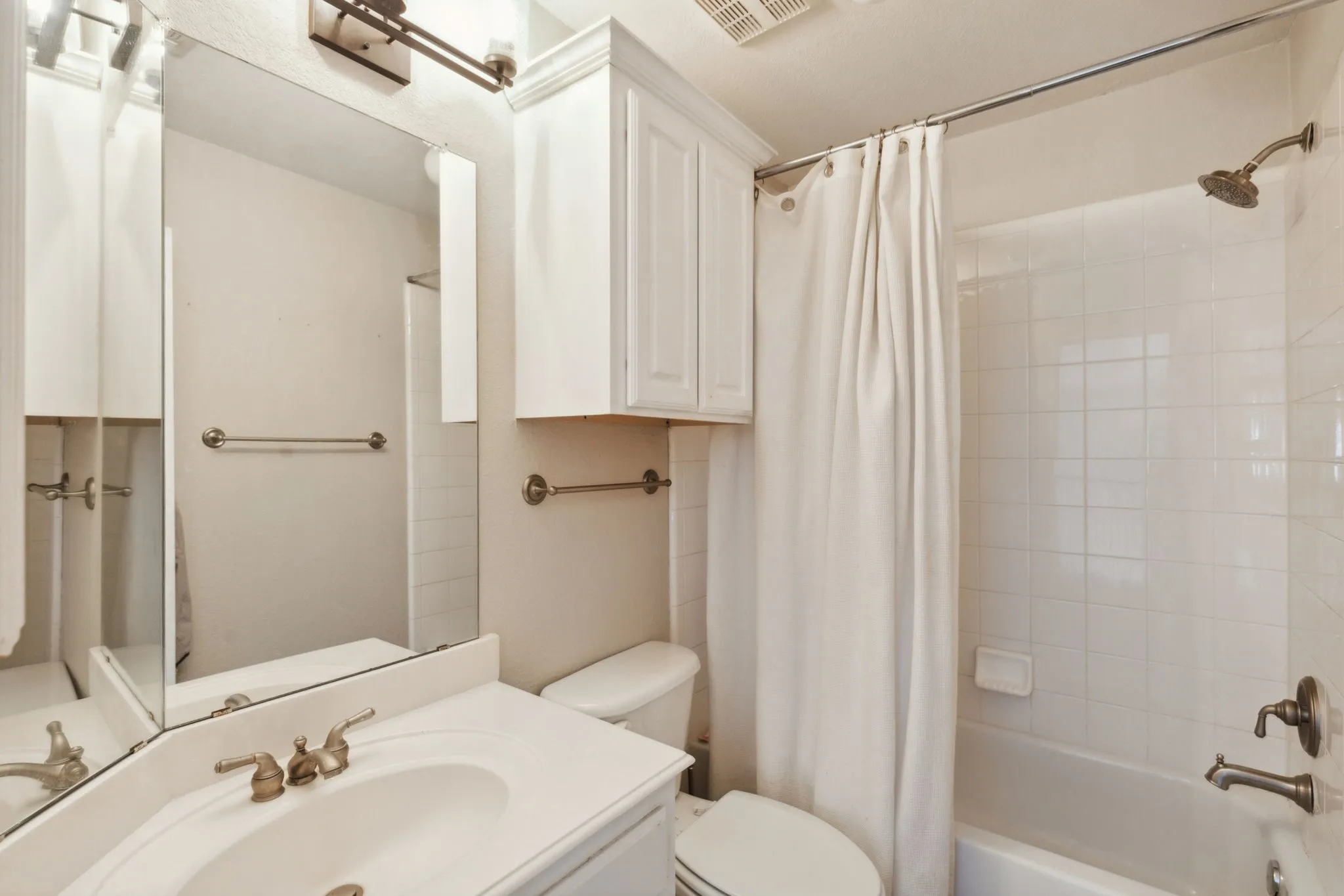 Ensuite bath has tub with shower.
