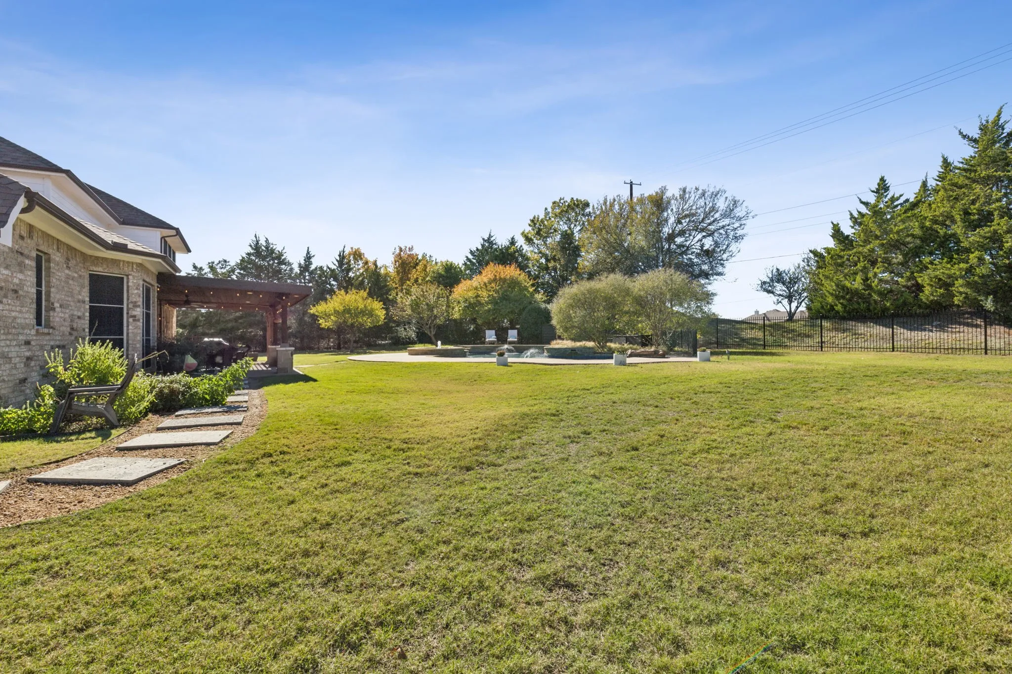 View from the side of the backyard toward the pool area.