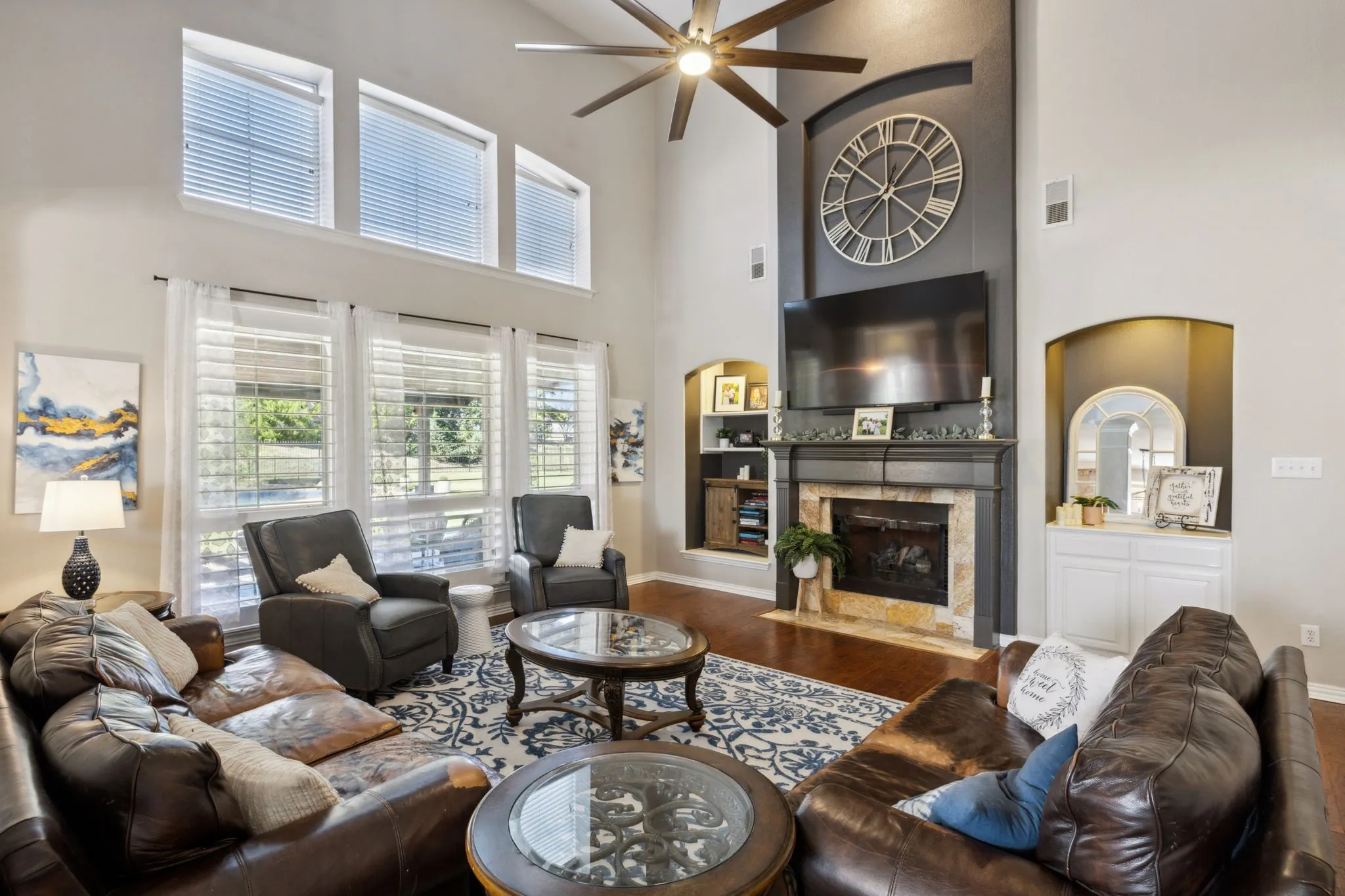 Spacious family room is anchored by an impressive fireplace with gas logs and tile surround. The space also enjoys great views of the pool and outdoor living area through double stacked windows that provide abundant natural light!