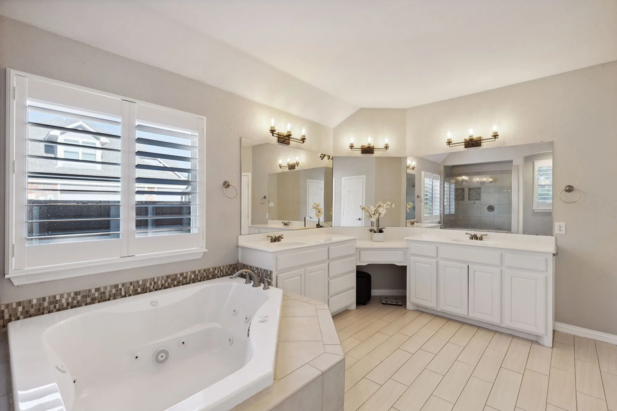 Large jetted tub is a great place to relax at the end of the day. The vanity provide wonderful storage.