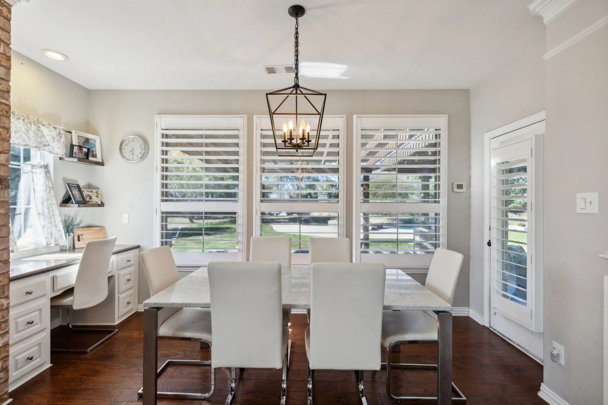Another view of the bright and cheerful nook area. Note, you have access to the back patio from the nook! The windows along the back wall as well as the door to the patio have Plantation Shutters.