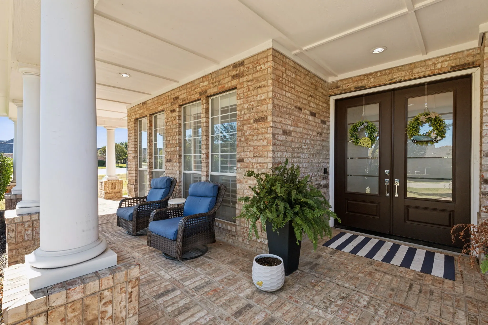 Welcome friends and family or just enjoy a relaxing moment on this spacious front porch. The details are beautiful from brick paving to graceful columns.