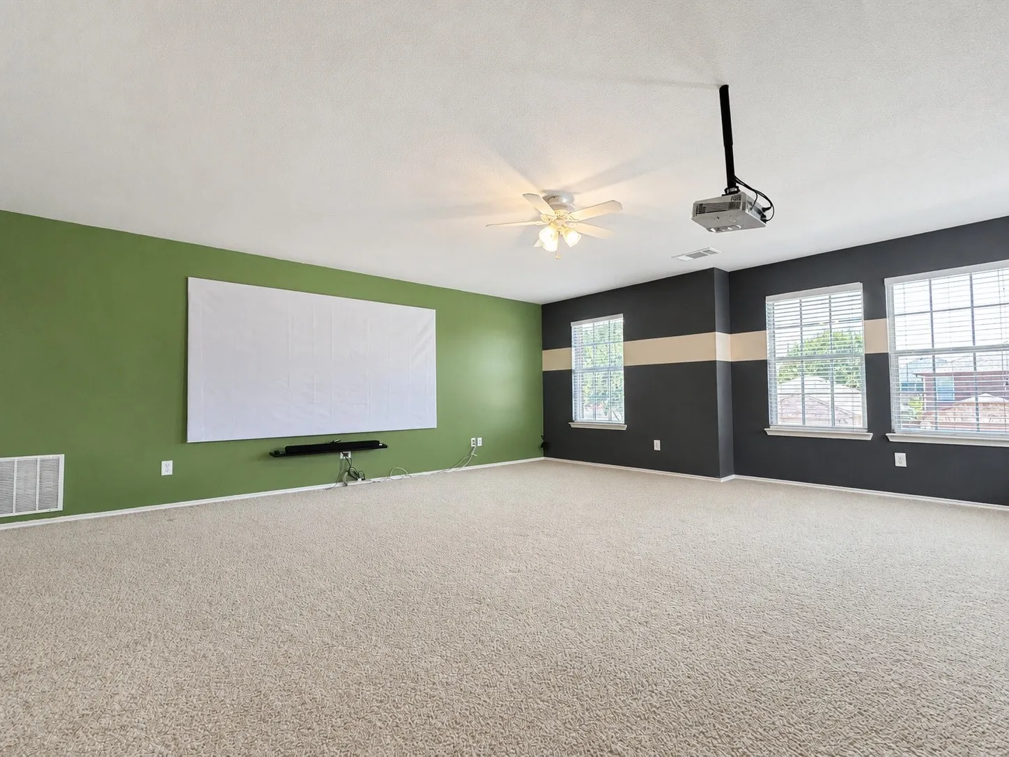 The media room includes a 120-inch screren, soundbar, and projector
