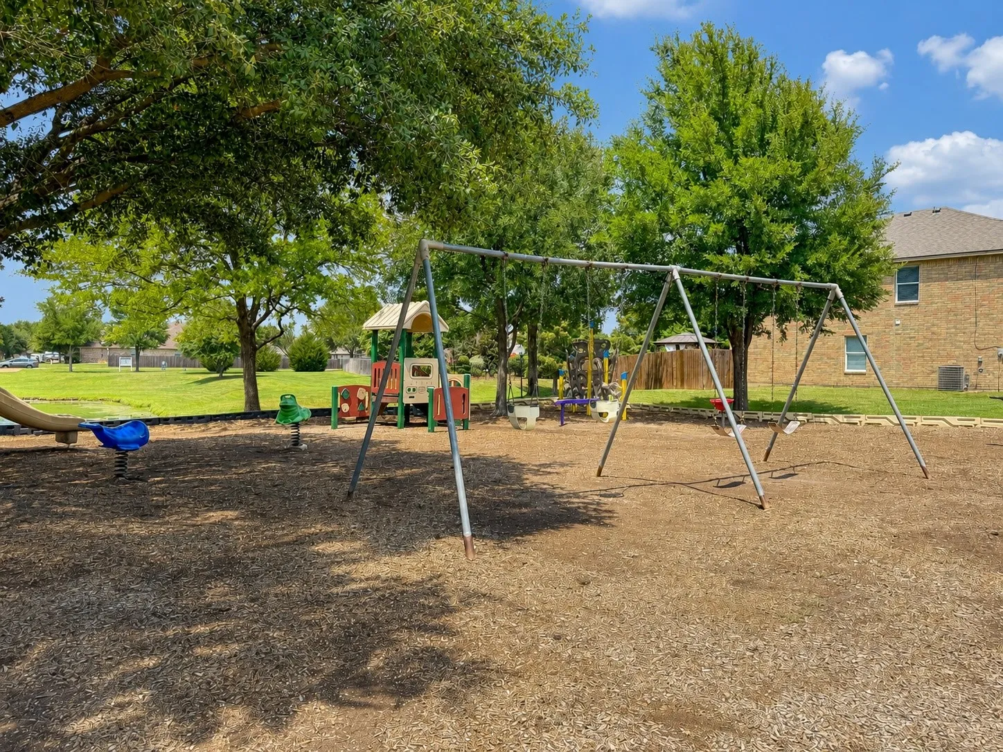The large greenspace area nearby includes a playground