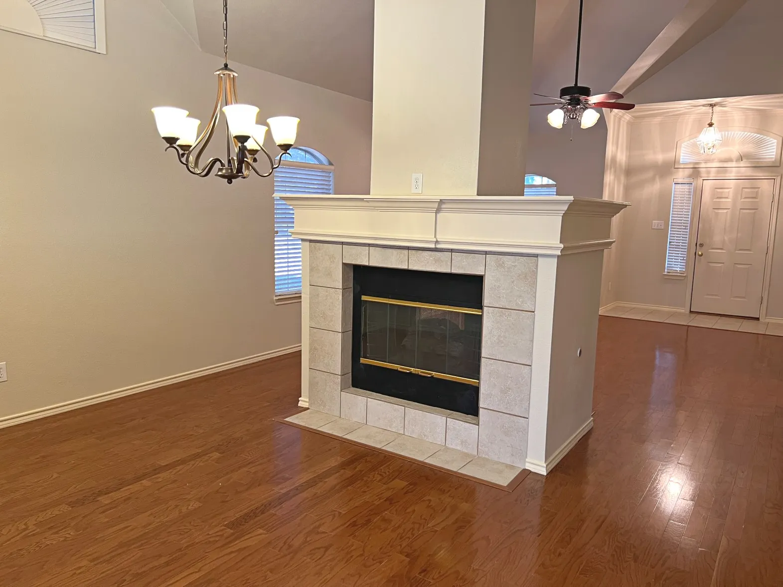 Tile surround fireplace with gas logs.