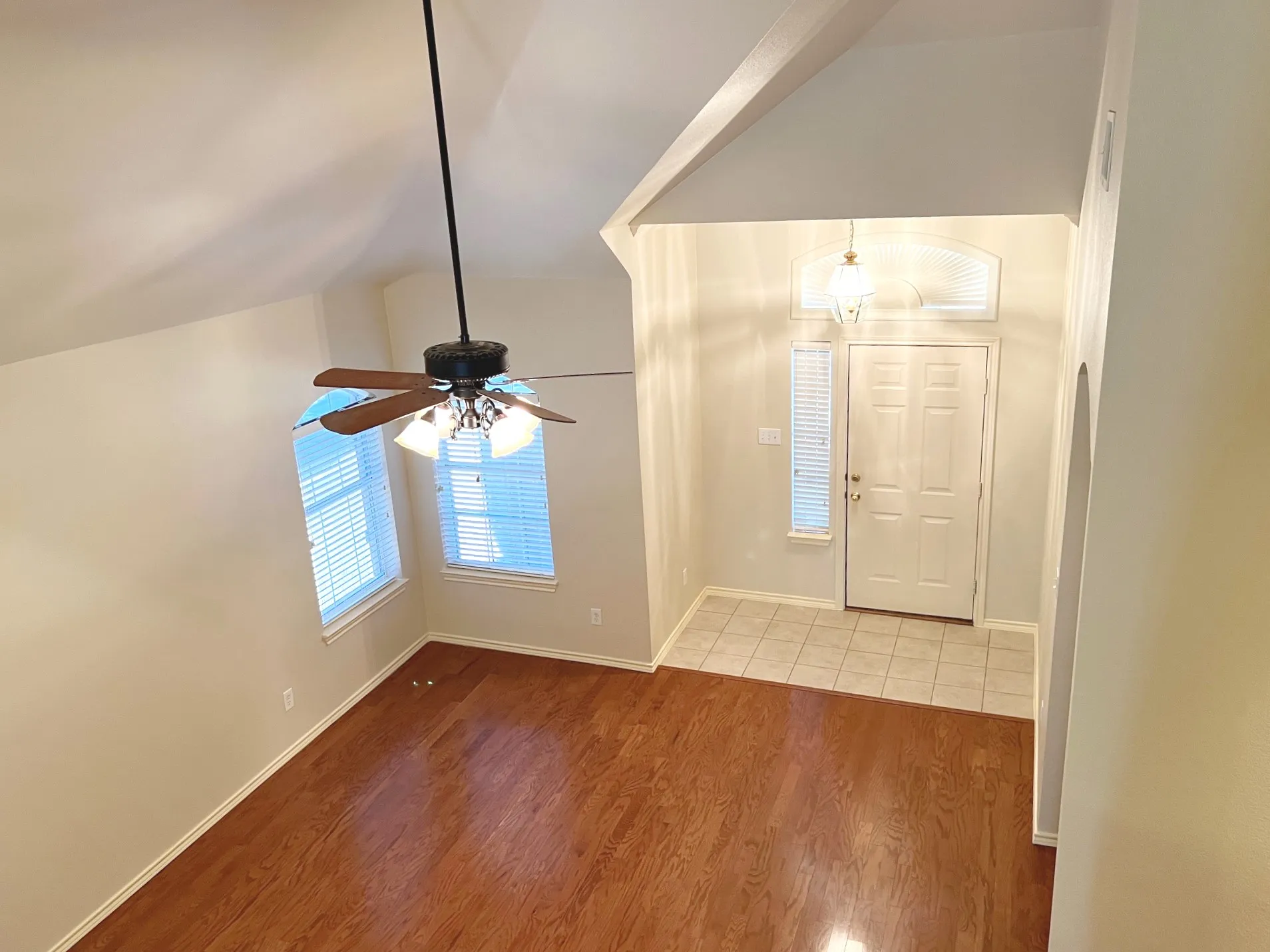 Entry to living room with laminate flooring and ceiling fan