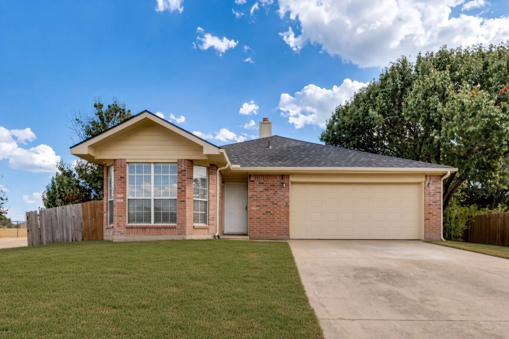 Brick exterior featuring a gabled roofing Ai was used to enhance grass appearance