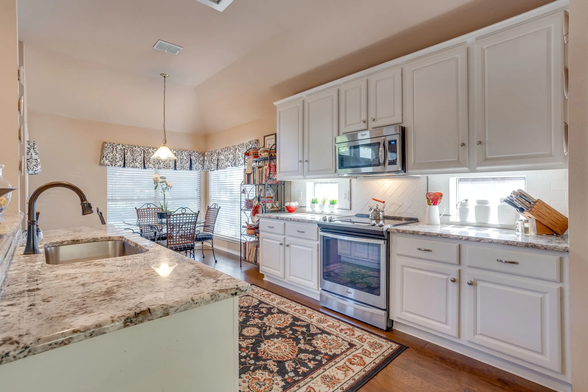 Updated Kitchen with granite countertops and herringhone tile.
