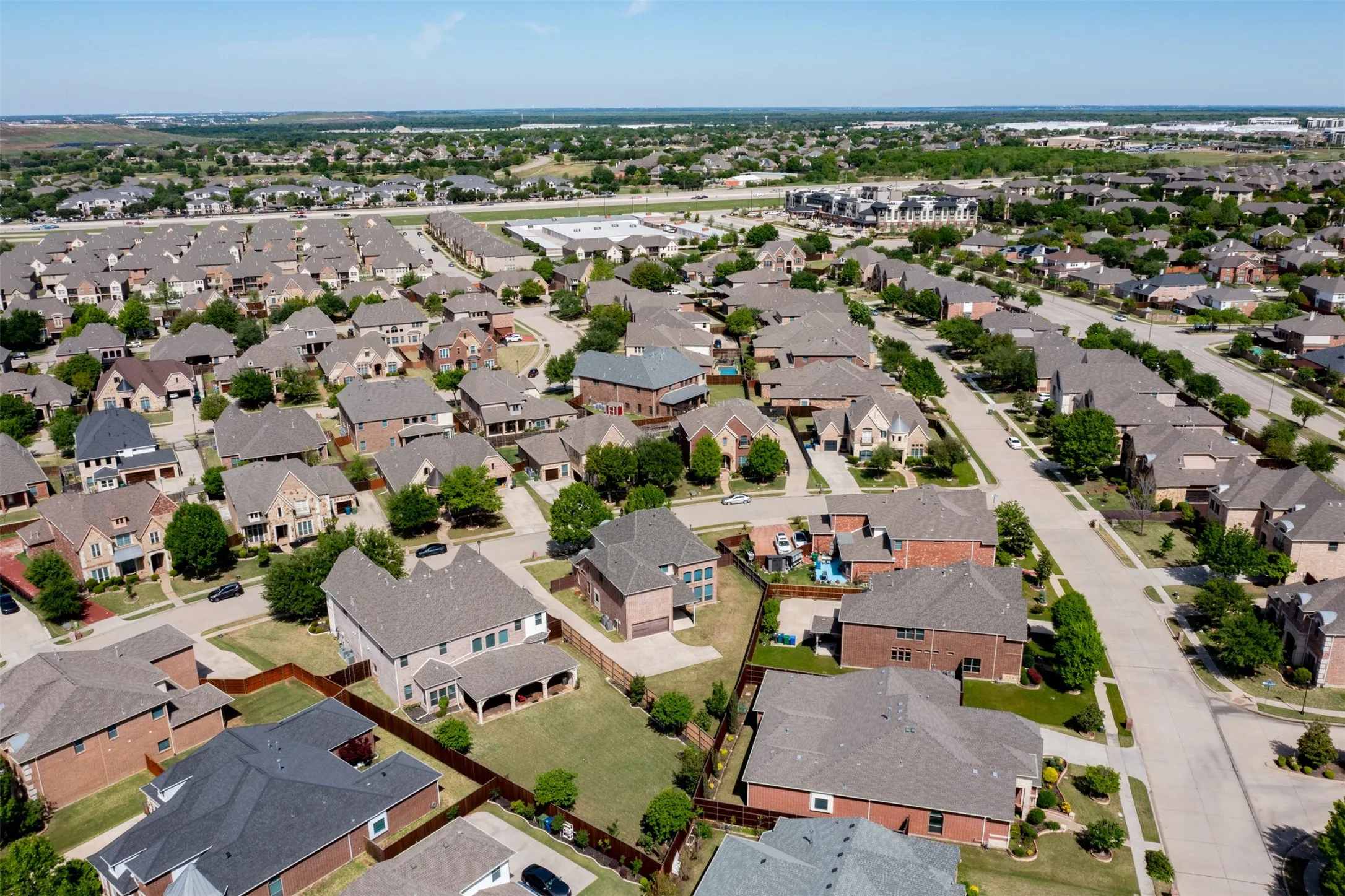 Aerial view of property's location featuring nearby suburban area