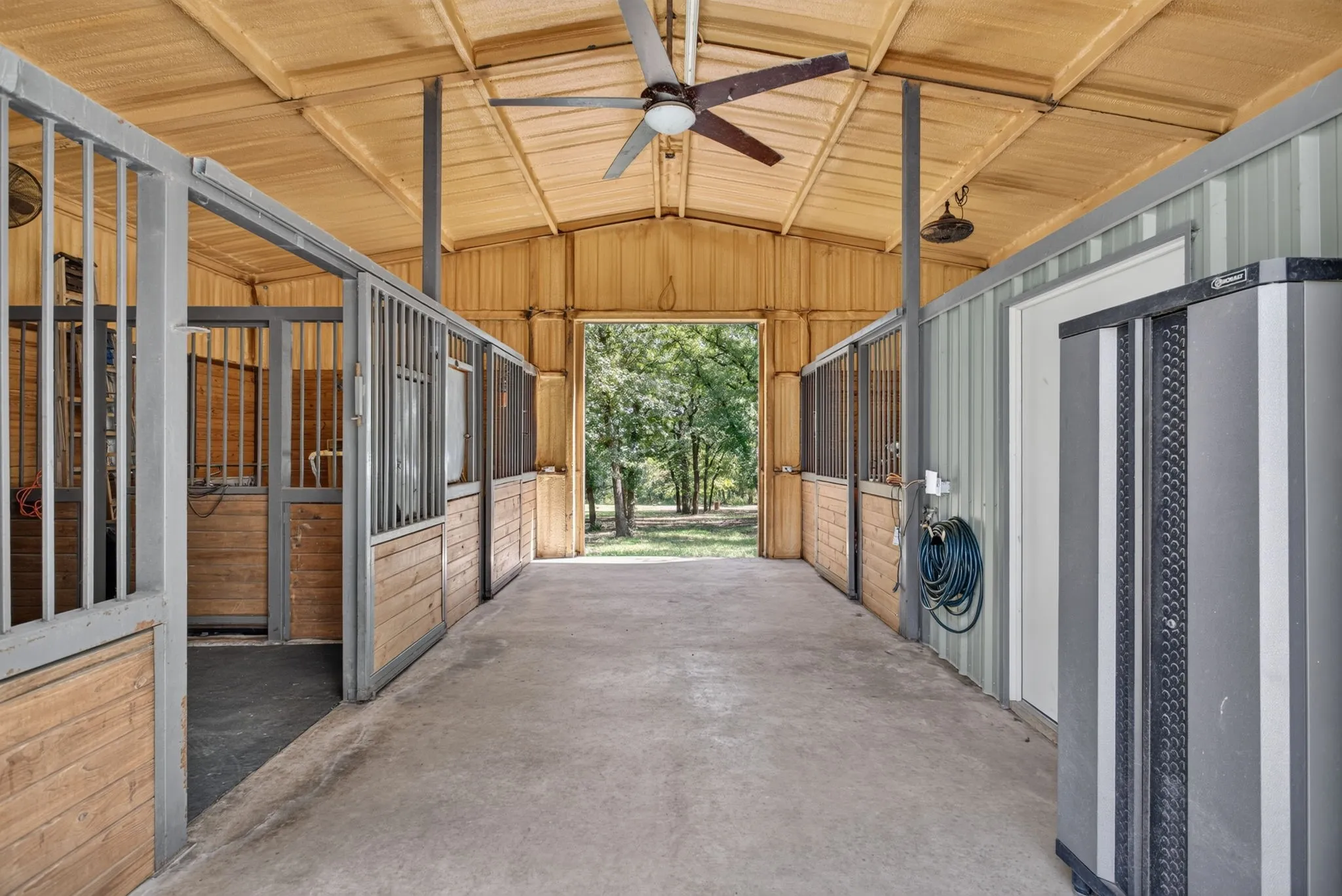 3 stall barn with air-conditioned tack room with a half bathroom