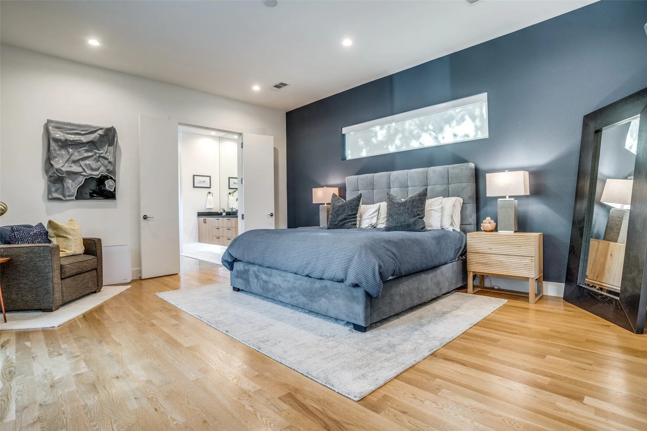 Oversized Bedroom with sitting space featuring 3.25' Grade A white oak hardwood floors and ensuite bathroom
