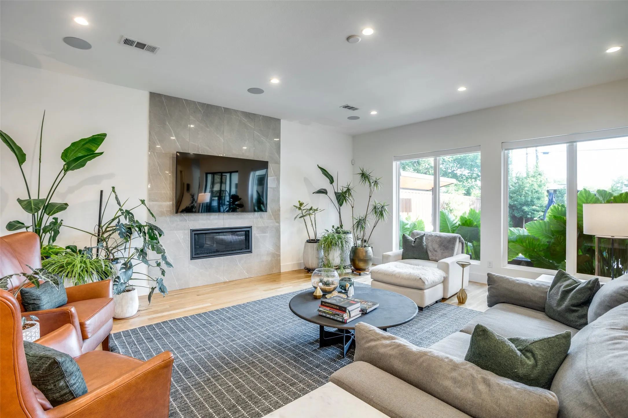 Living room has auto ignite gas lighted stone fireplace. Large energy efficient low e3 double pane windows over looking the beautiful back yard. Electric blinds and full length sliding glass doors.