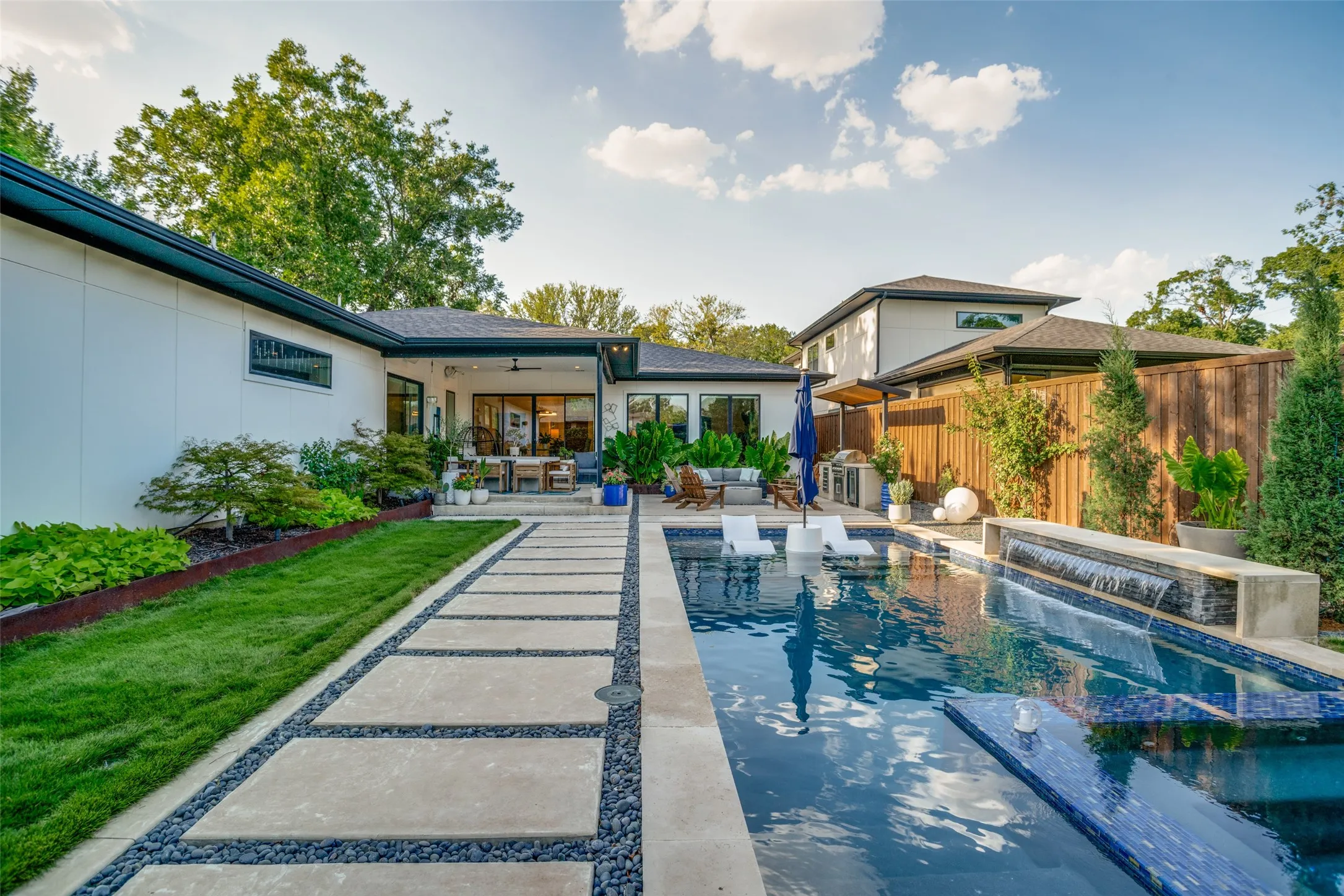 View of swimming pool features patio area, an outdoor living space, and a pool with connected hot tub