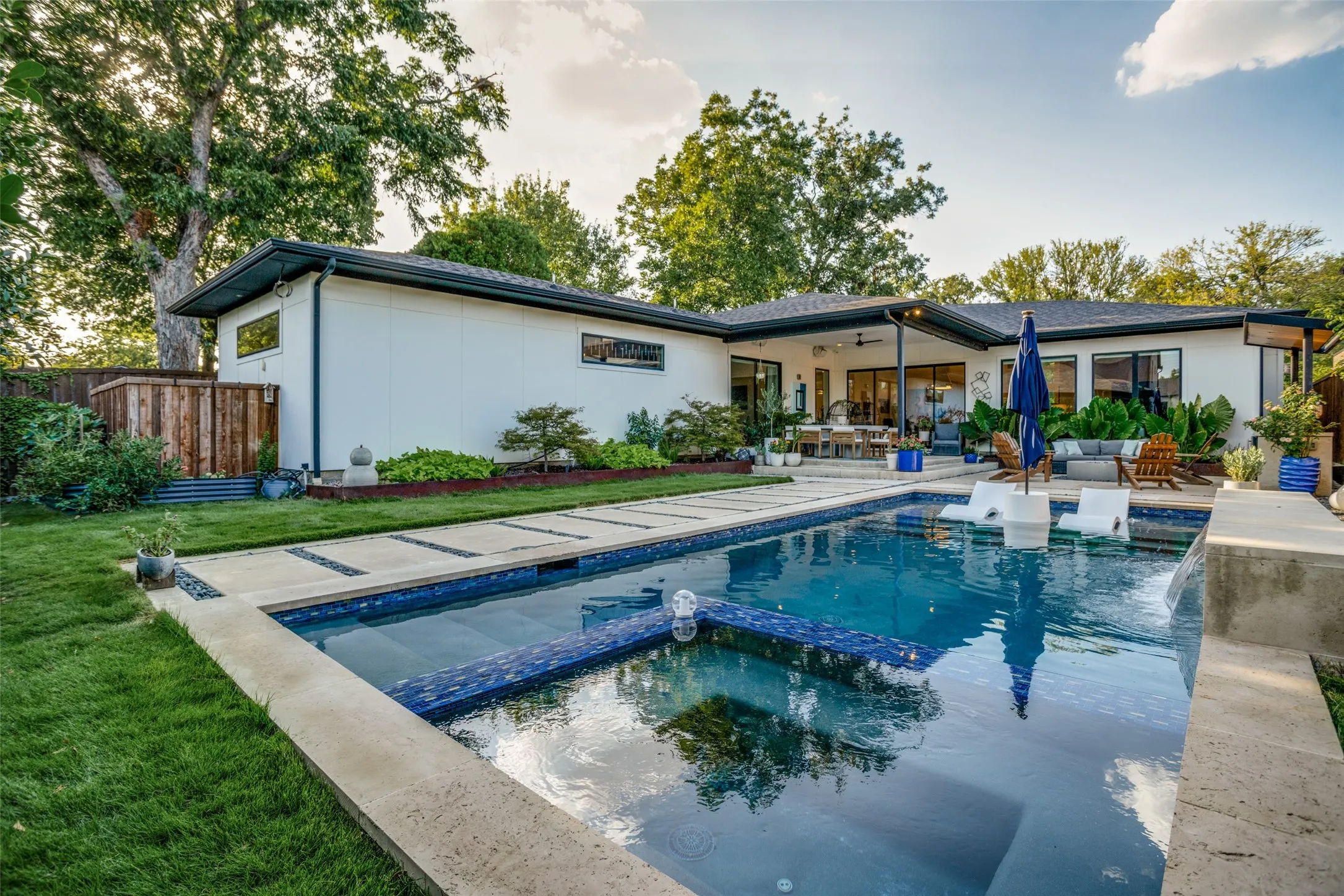 Rear view of house with a pool with connected hot tub, a patio area, a ceiling fan, and an outdoor living space