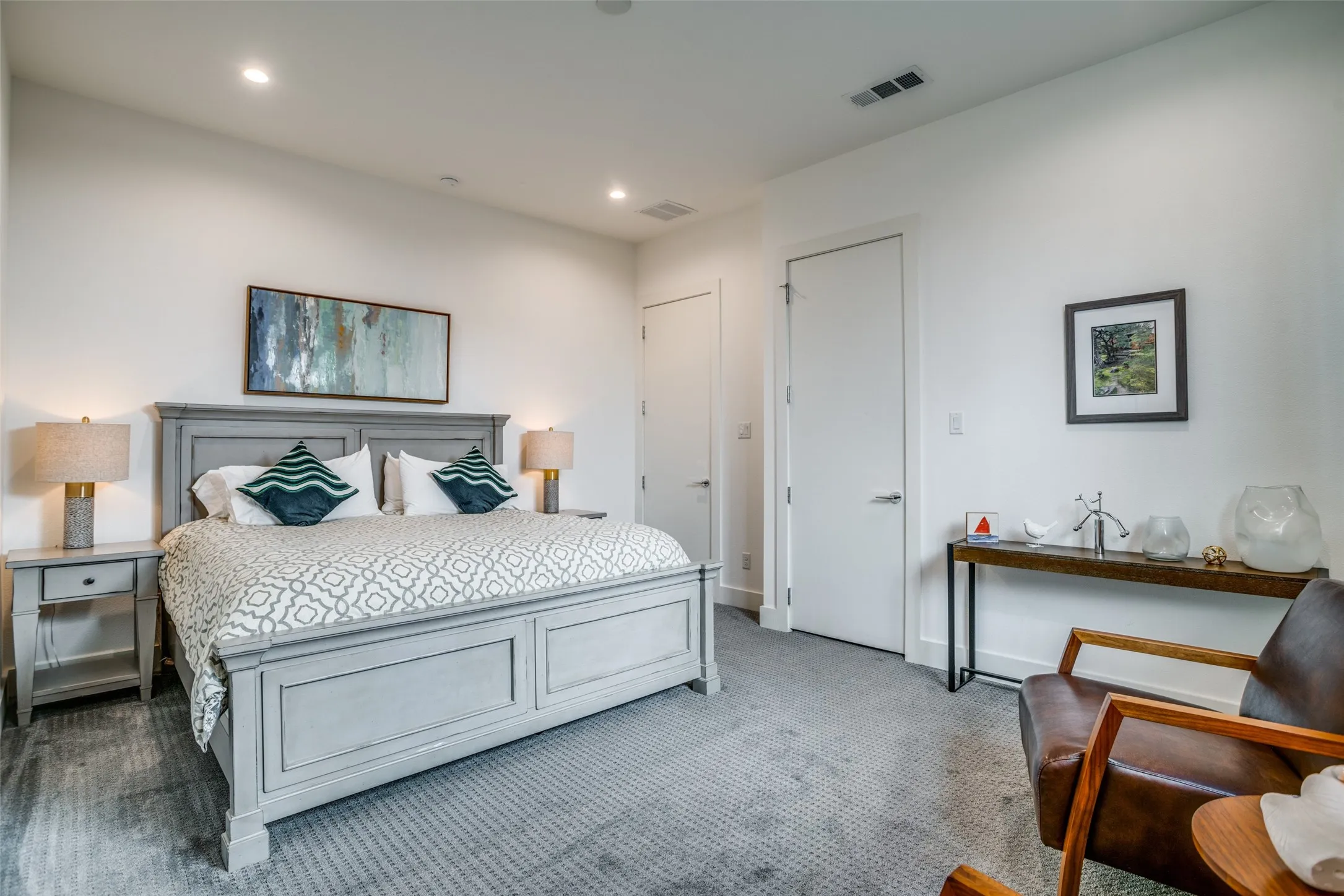 Premium Dream Weaver carpeted bedroom with baseboards and recessed lighting.