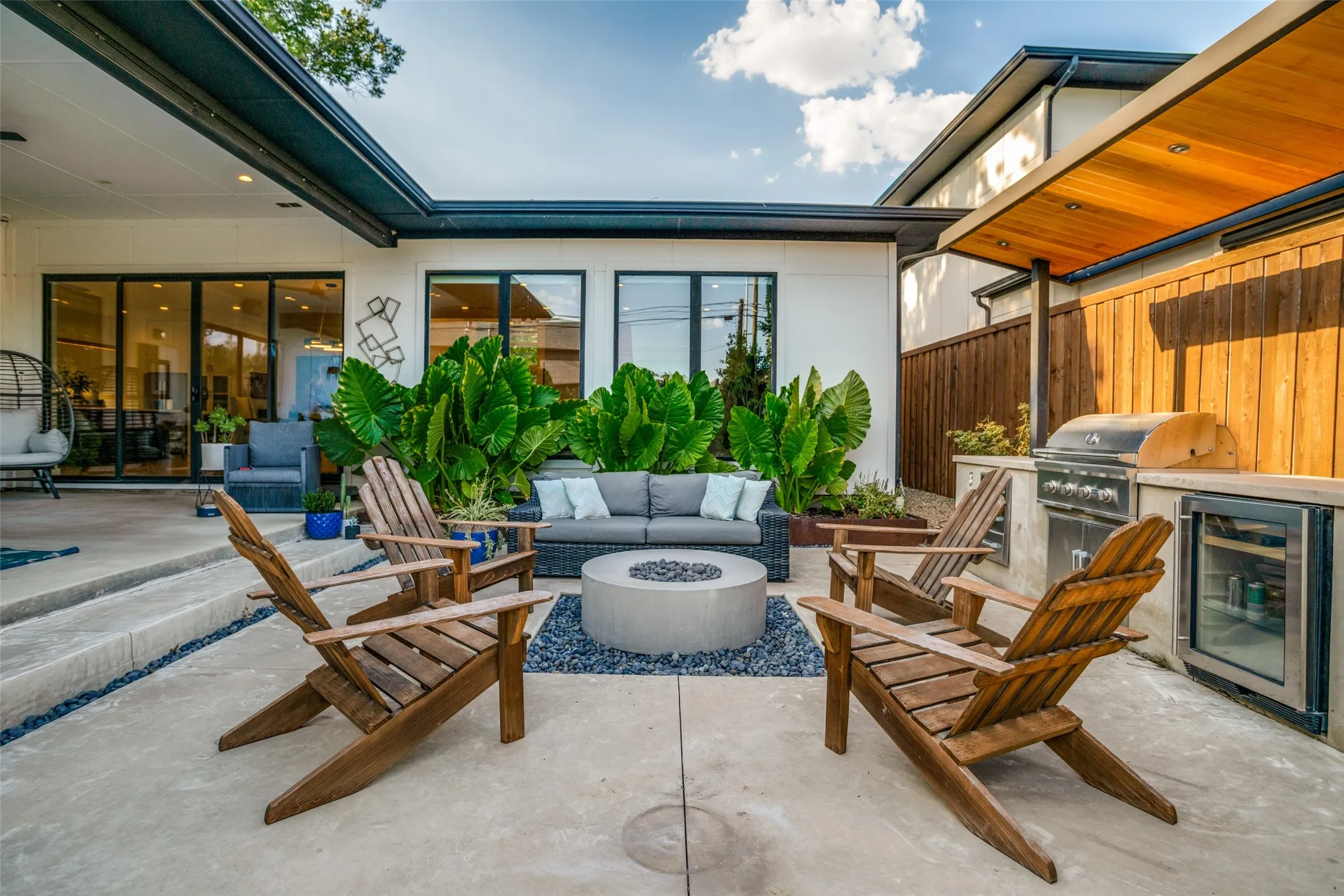 View of patio featuring an outdoor living space with a fire pit, wine cooler, and exterior kitchen