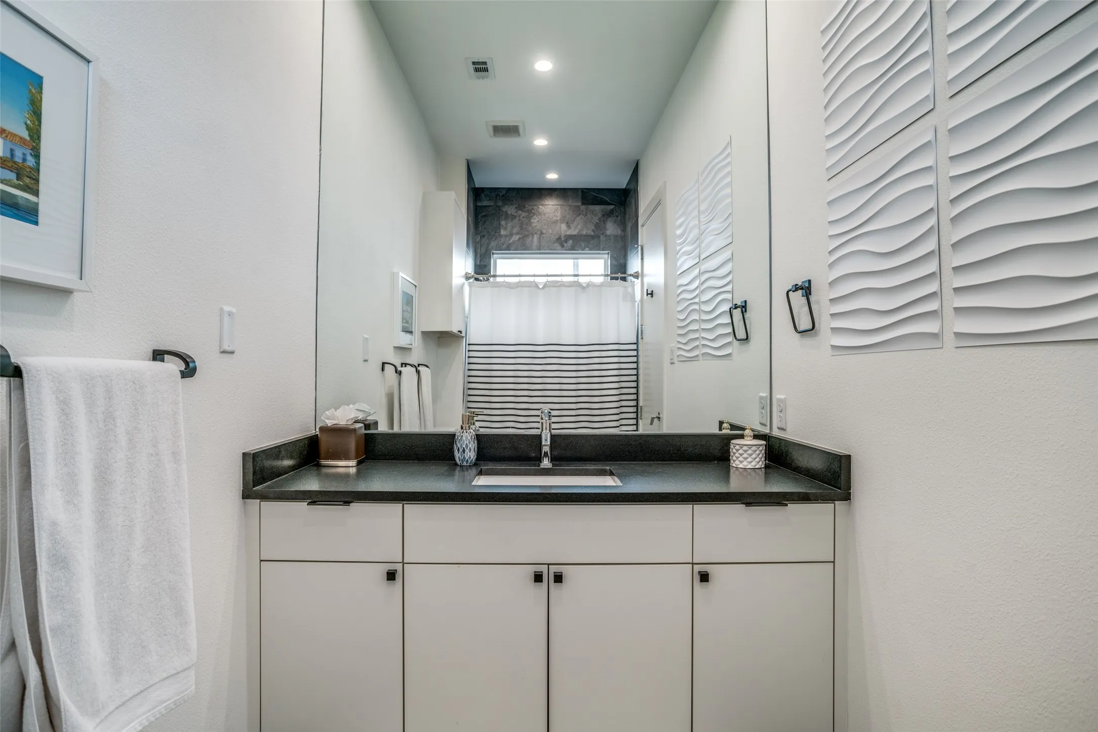Bathroom featuring vanity, a shower with curtain, and recessed lighting