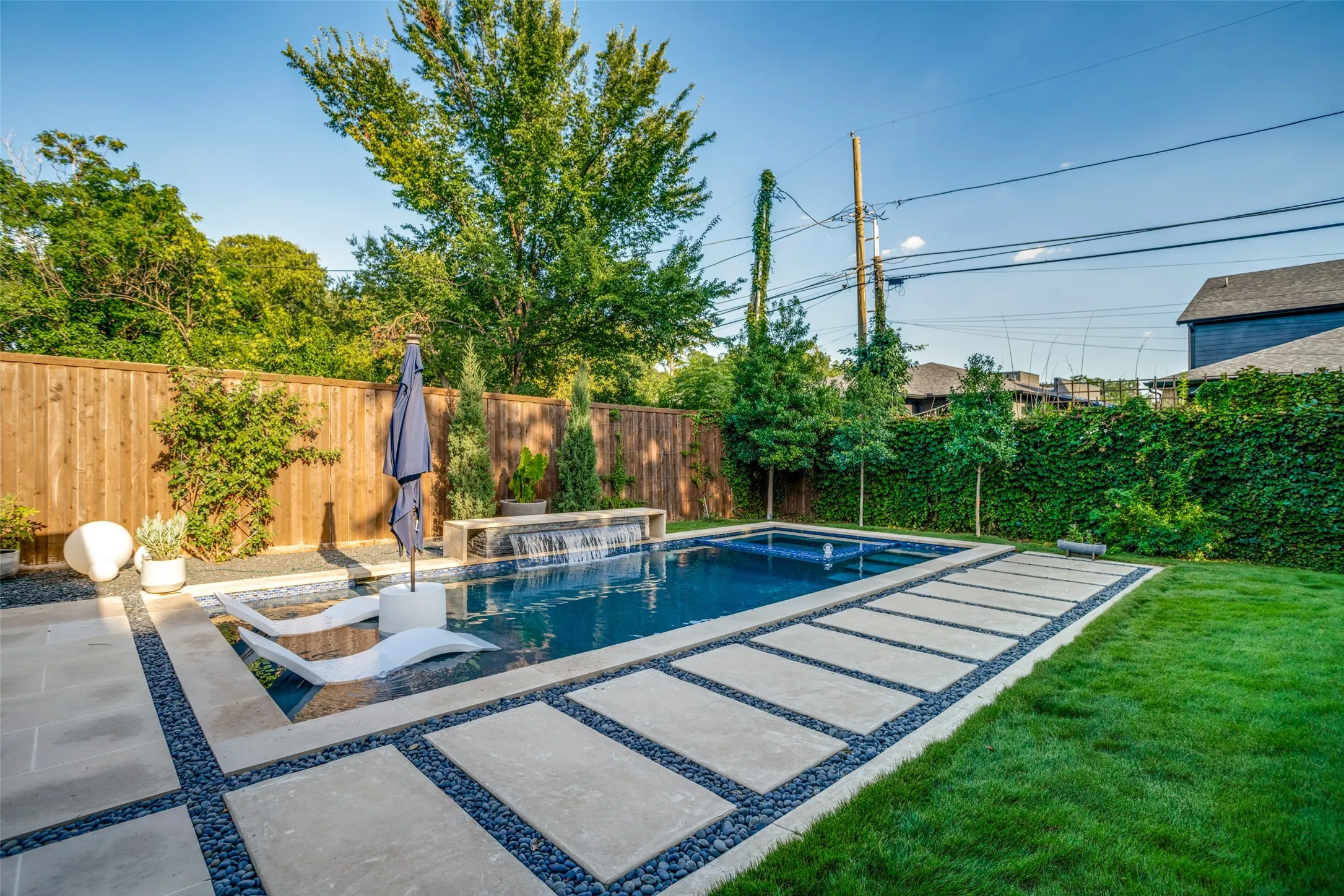 The salt water pool contains an inviting spa and a tanning ledge.  Gorgeous cement pavers are surrounded by river rock giving easy access  to the pool.