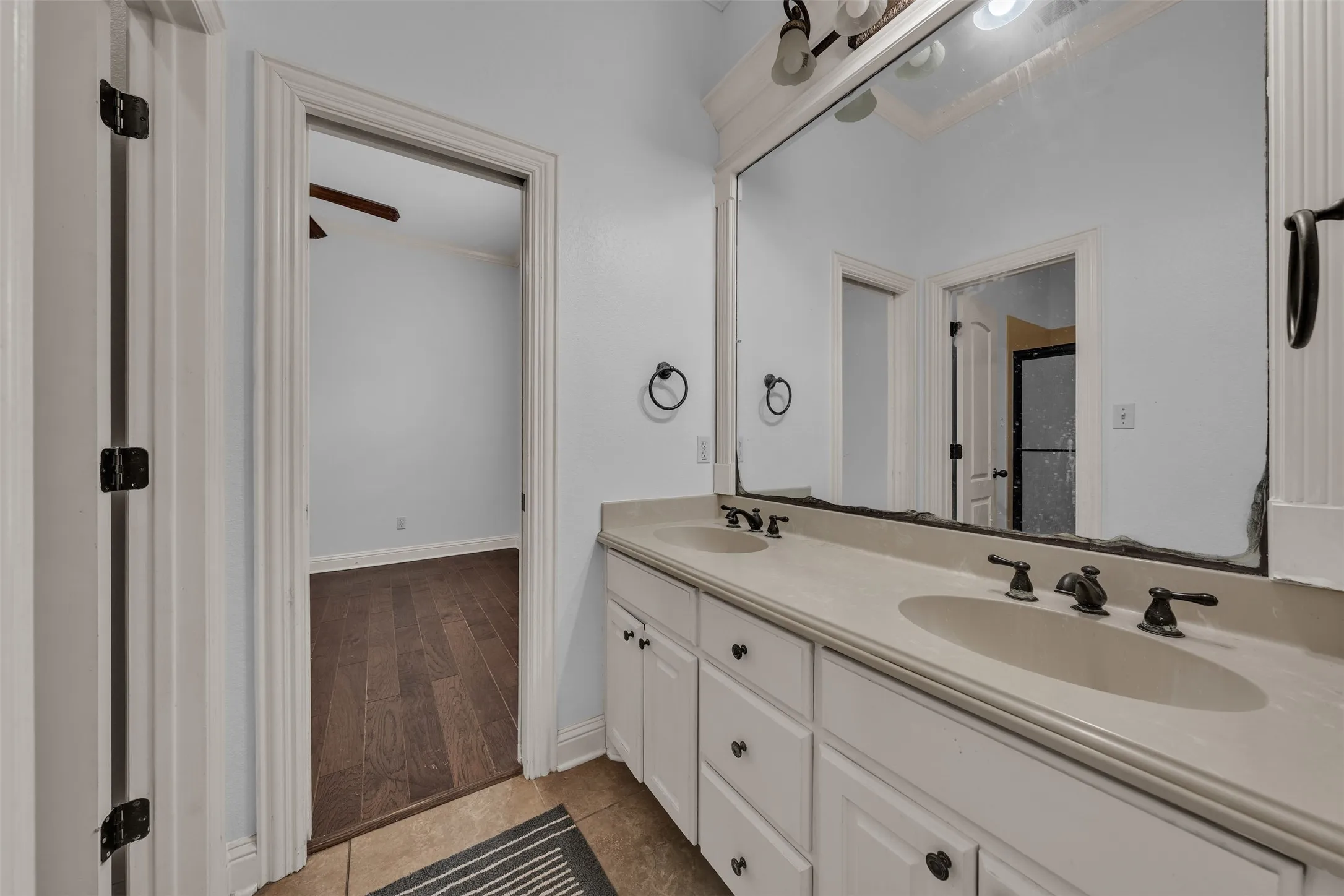 Double vanity featuring integrated sinks and oil-rubbed bronze fixtures