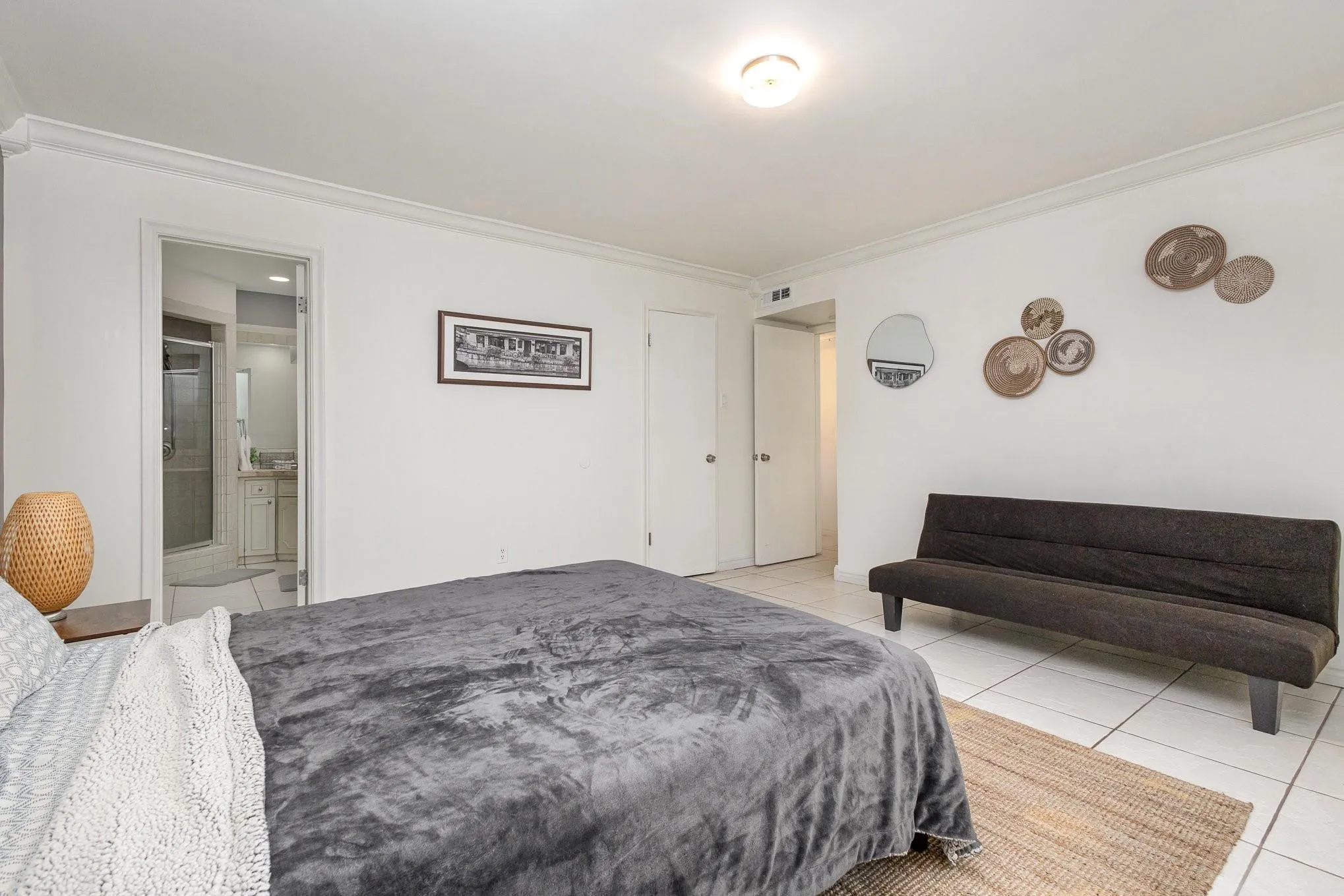 Bedroom featuring white tile flooring and crown molding