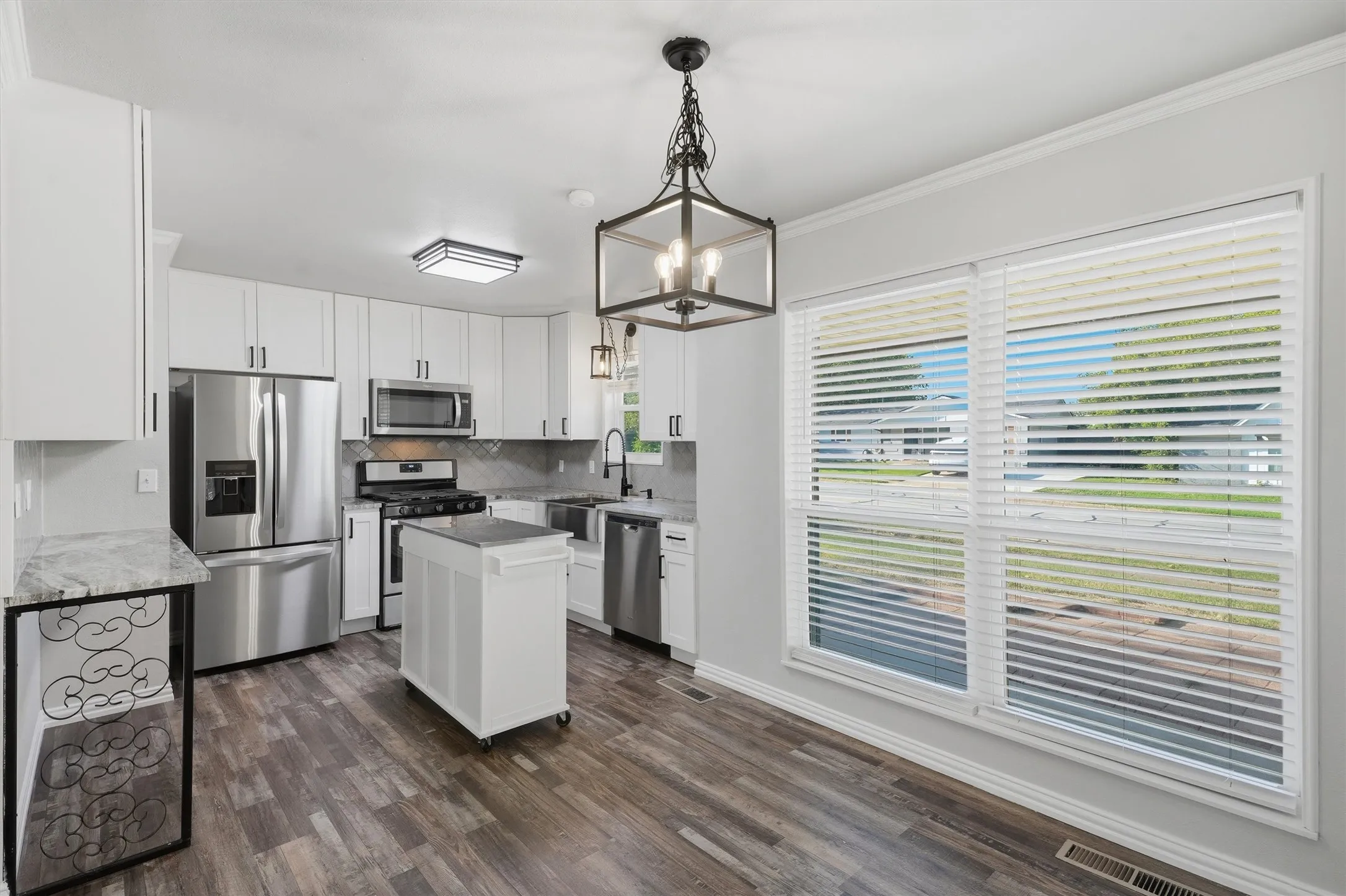 Fabulous kitchen all appliances convey with a rolling island.
