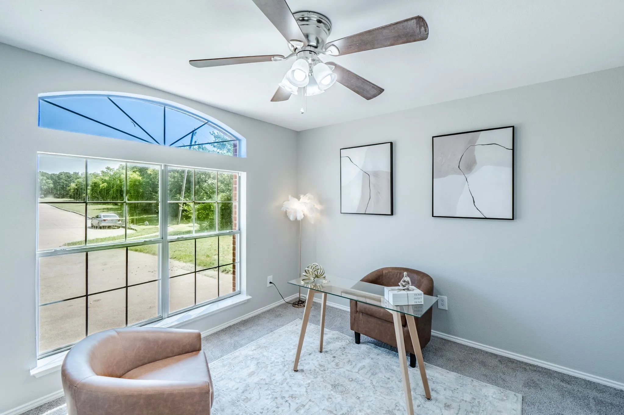 Room featuring a large picture window with a transom, providing ample natural light