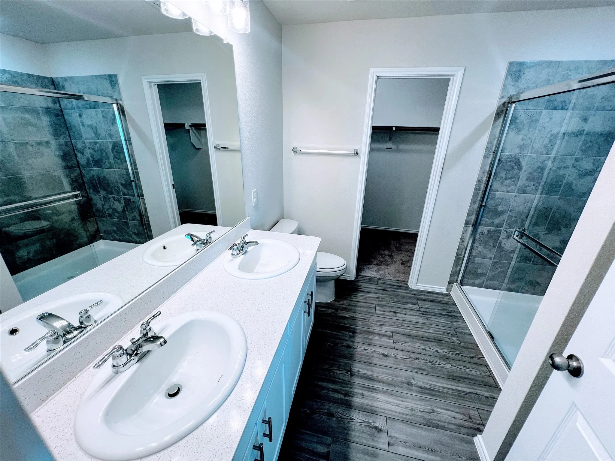 Bathroom with a dual vanity featuring white oval sinks and chrome fixtures