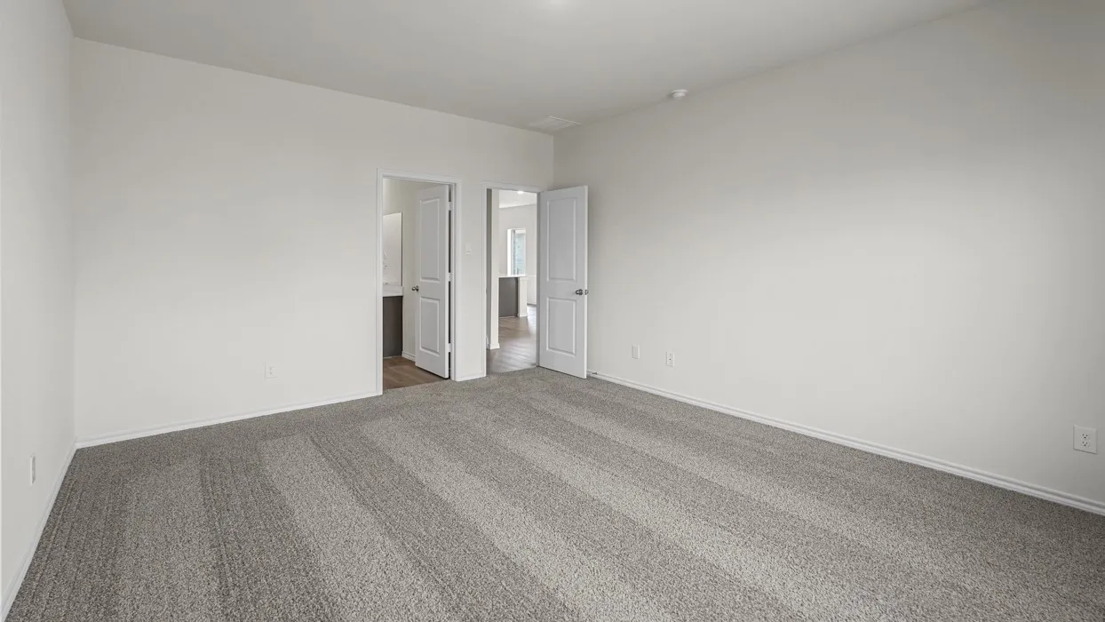 Spacious room featuring light gray carpeting and white painted walls